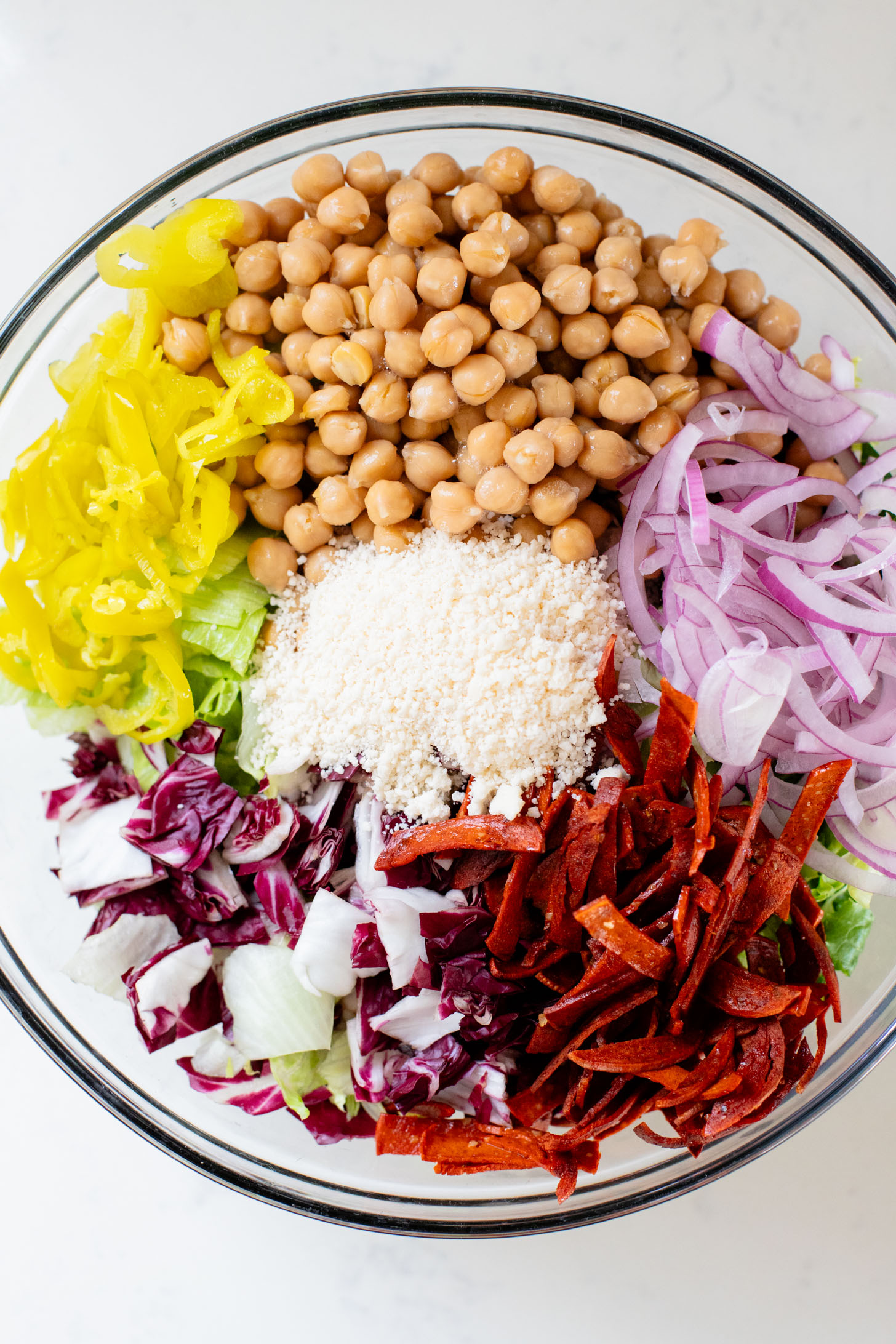 This Pizza Night Chopped Salad is the perfect side for, you guessed it, pizza night! Crunchy veggies, vegan pepperoni & a tangy dressing | ThisSavoryVegan.com