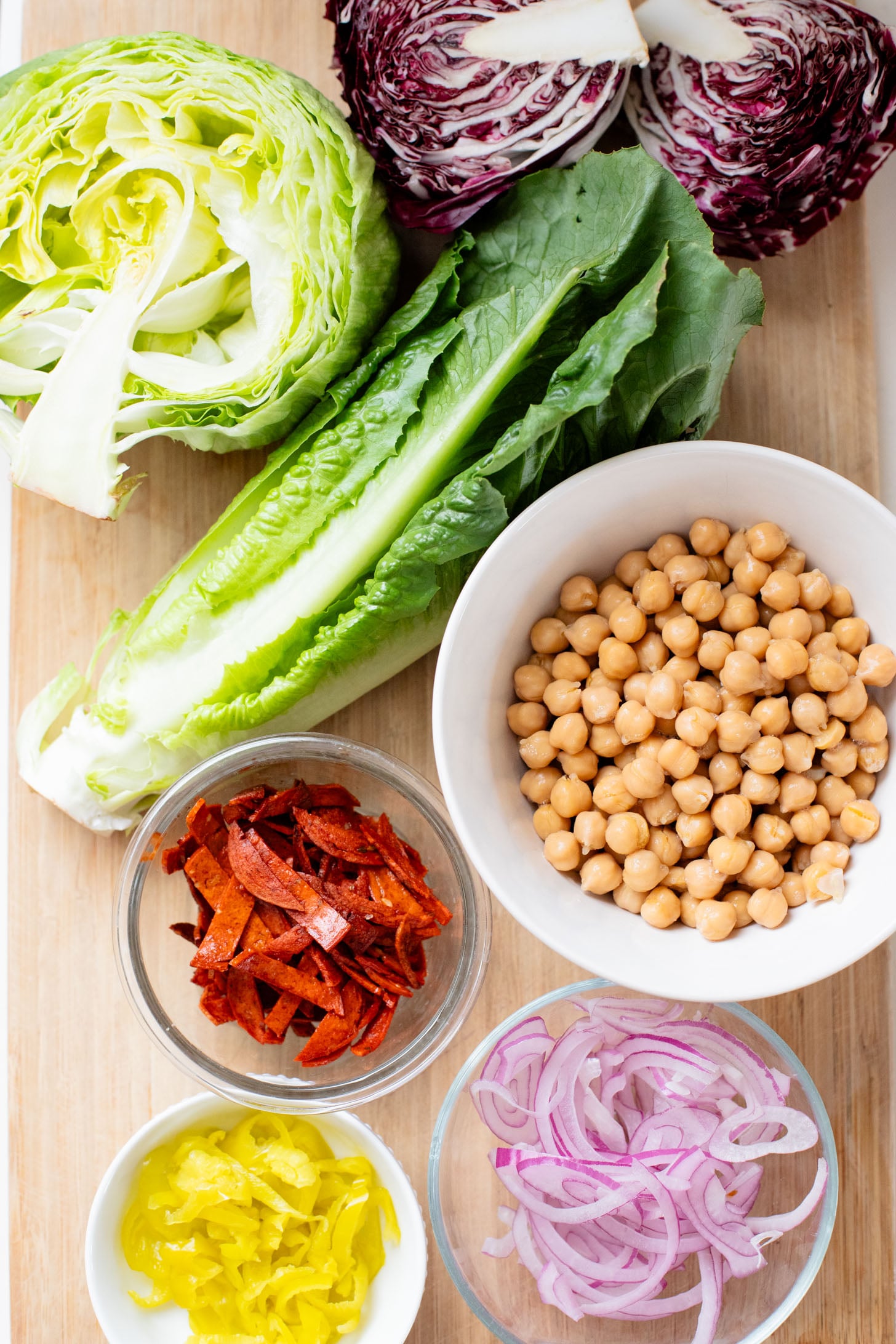 This Pizza Night Chopped Salad is the perfect side for, you guessed it, pizza night! Crunchy veggies, vegan pepperoni & a tangy dressing | ThisSavoryVegan.com