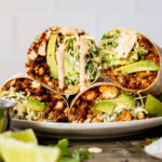 These Sheet Pan Tofu Burritos are filled with crispy tofu, shredded cabbage, cilantro, onions, avocado and dairy-free chipotle mayo | ThisSavoryVegan.com