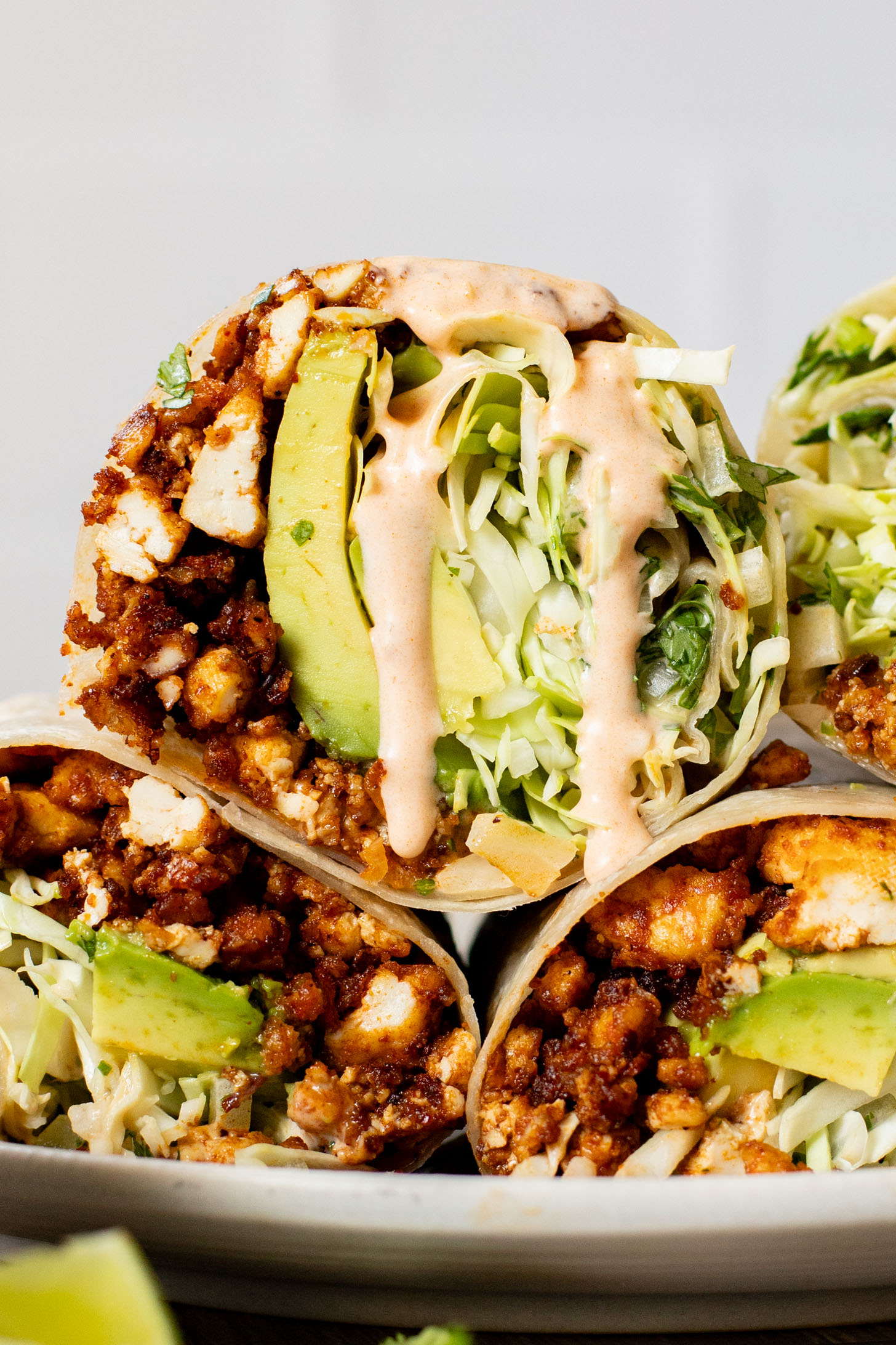 These Sheet Pan Tofu Burritos are filled with crispy tofu, shredded cabbage, cilantro, onions, avocado and dairy-free chipotle mayo | ThisSavoryVegan.com