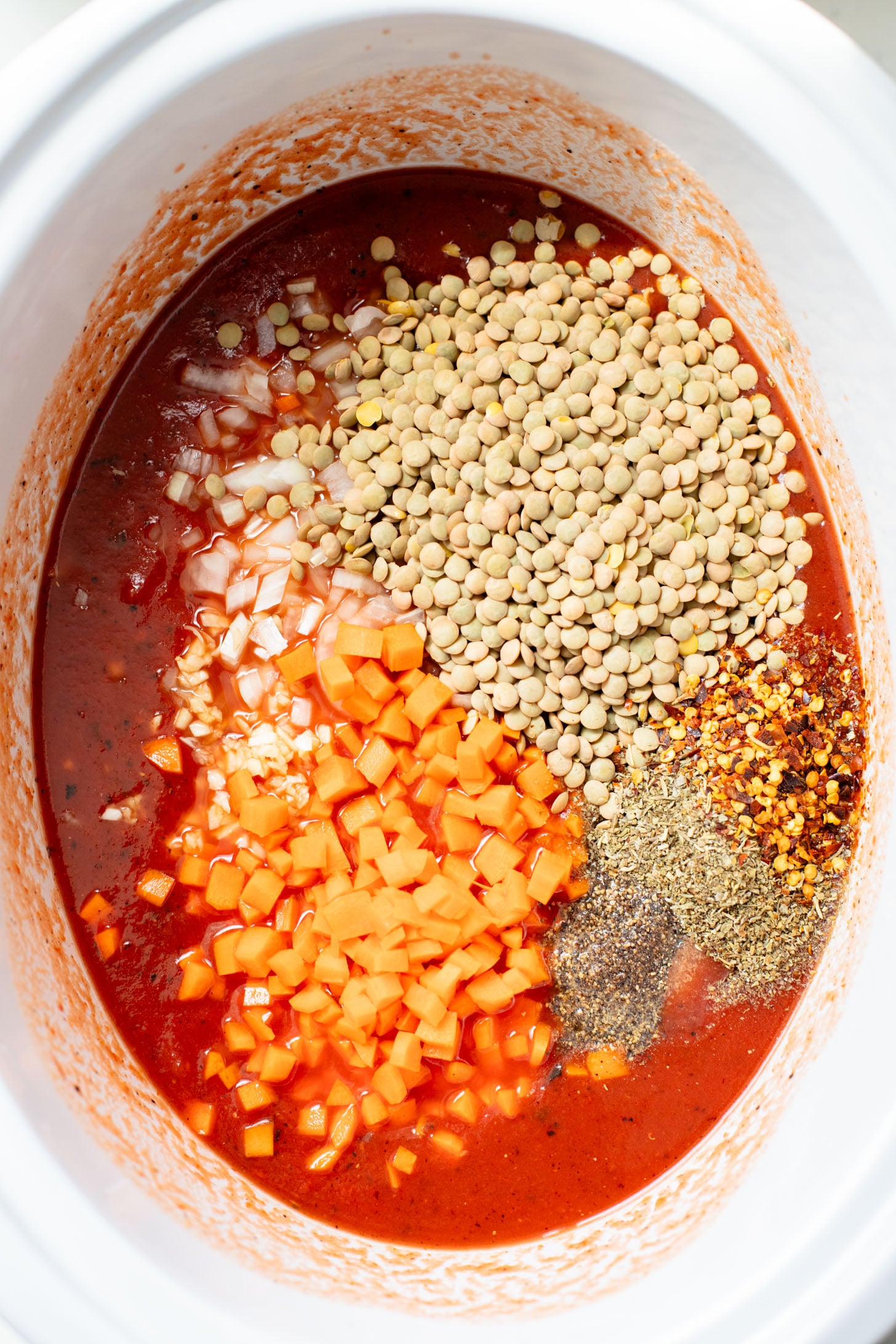This Slow Cooker Lentil Bolognese is the perfect vegan Sunday sauce! Served over pasta for a delicious, protein-packed dinner idea | ThisSavoryVegan.com