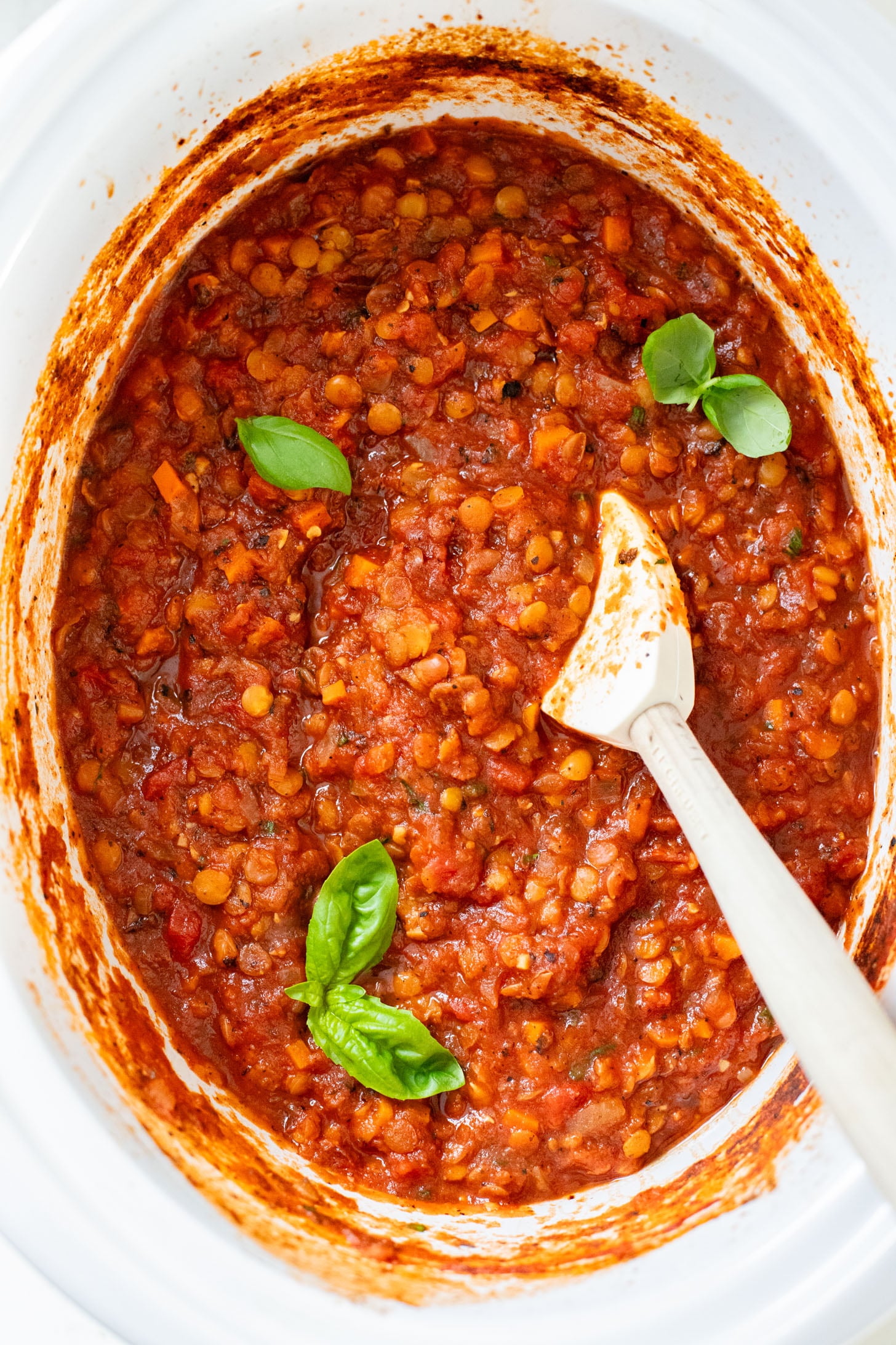 This Slow Cooker Lentil Bolognese is the perfect vegan Sunday sauce! Served over pasta for a delicious, protein-packed dinner idea | ThisSavoryVegan.com