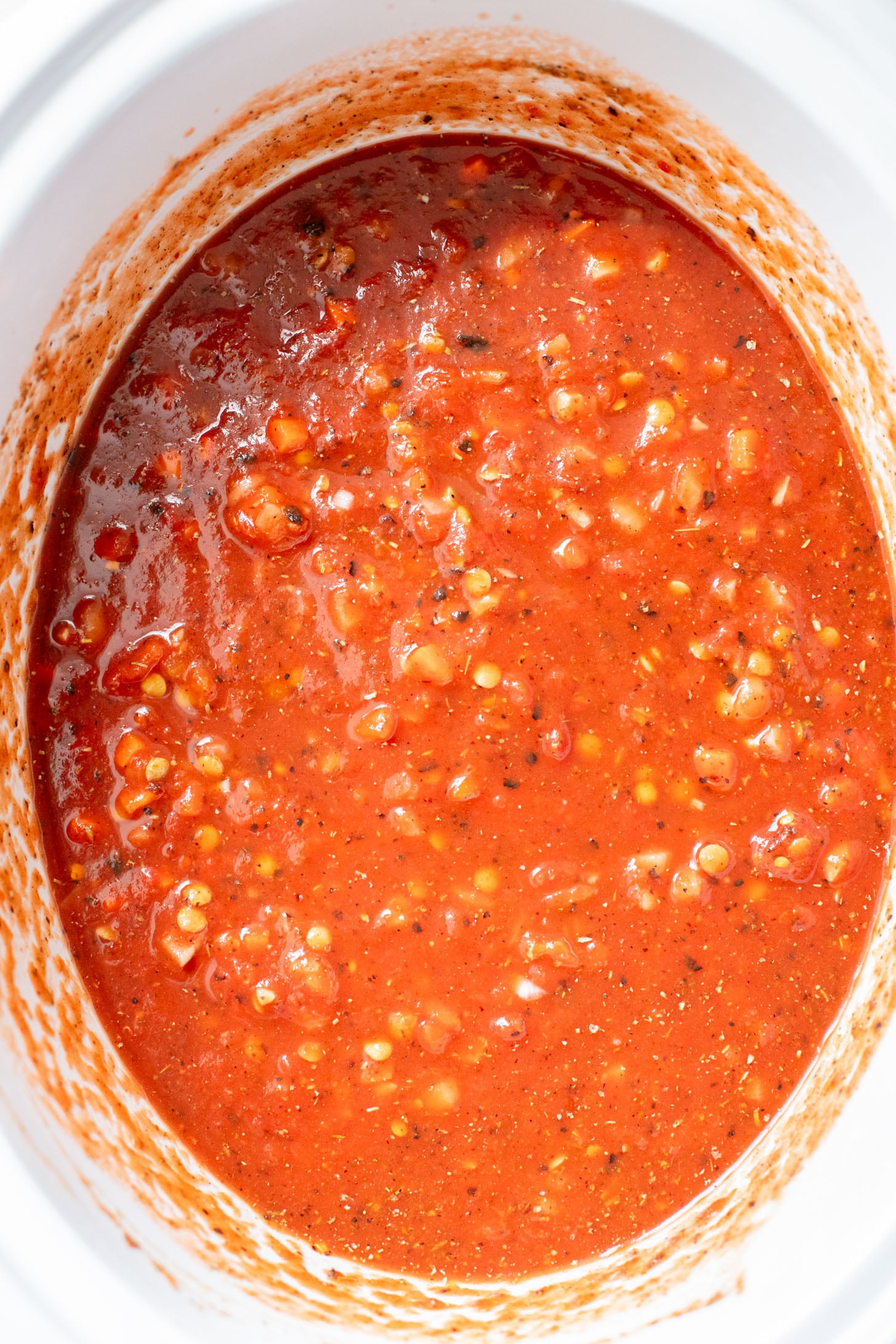 This Slow Cooker Lentil Bolognese is the perfect vegan Sunday sauce! Served over pasta for a delicious, protein-packed dinner idea | ThisSavoryVegan.com