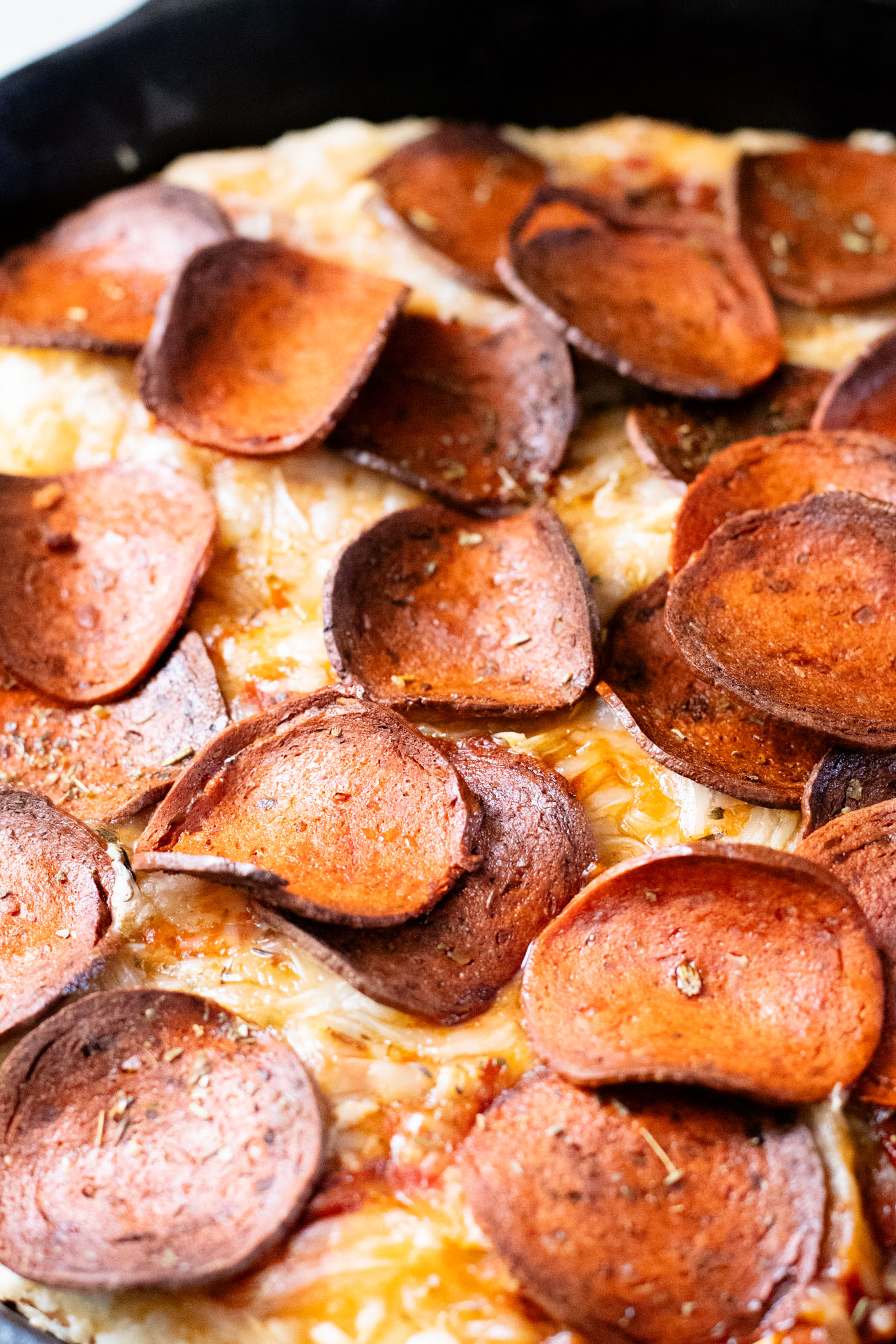 Thick crust, made in a cast iron skillet and extra cheesy. This Vegan Pepperoni Pan Pizza is 100% dairy-free and super delicious | ThisSavoryVegan.com