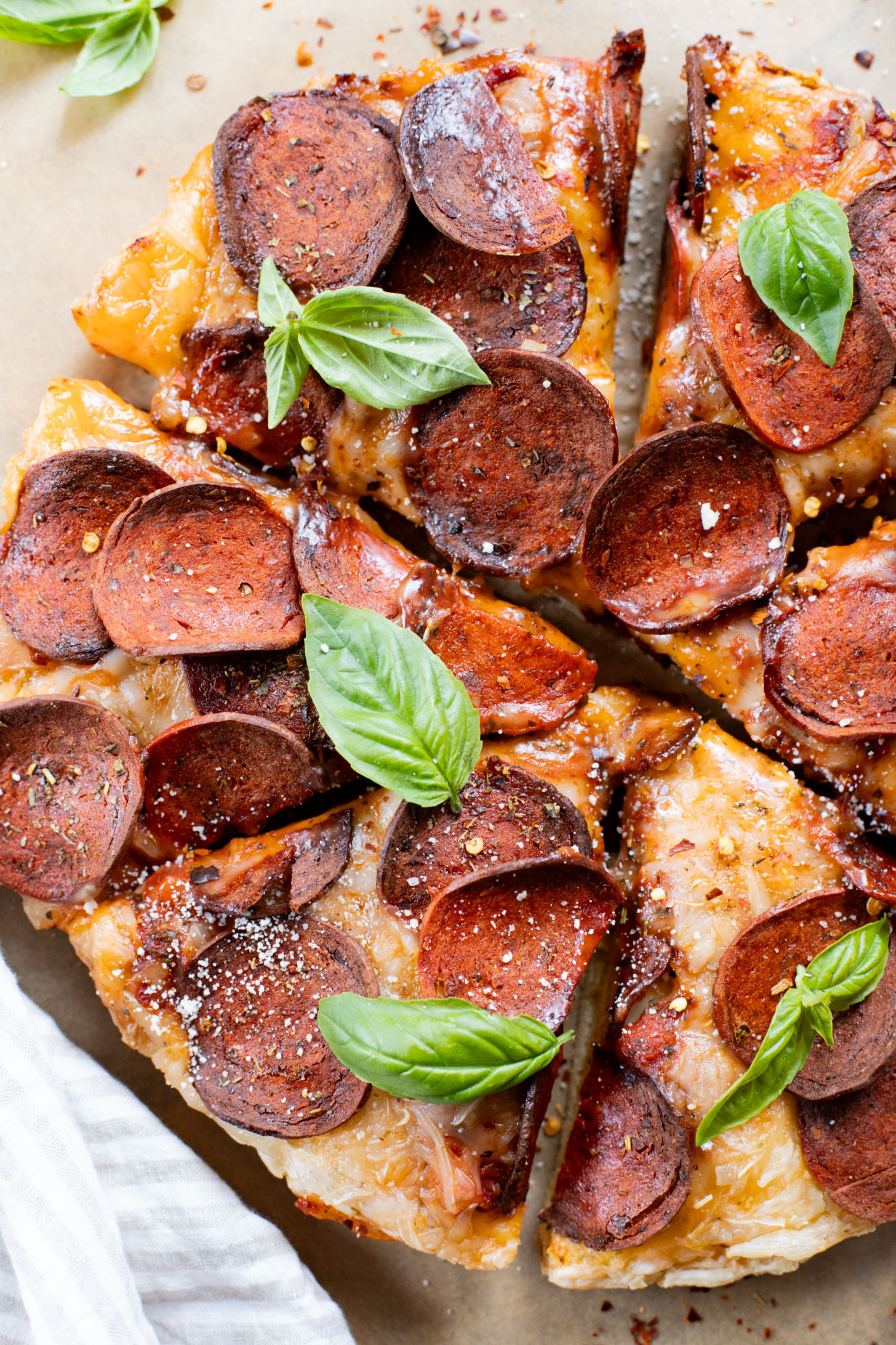 Thick crust, made in a cast iron skillet and extra cheesy. This Vegan Pepperoni Pan Pizza is 100% dairy-free and super delicious | ThisSavoryVegan.com