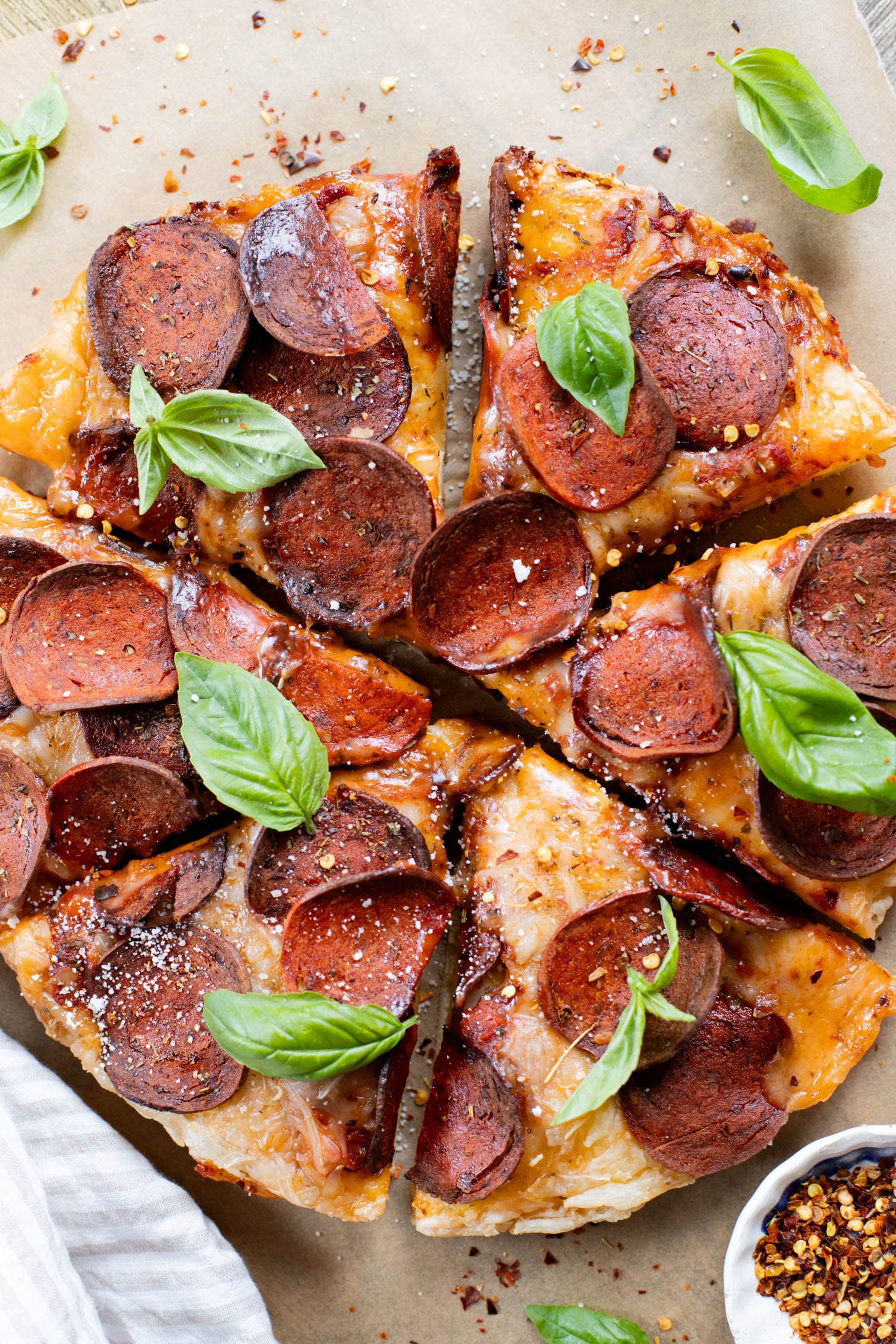 Thick crust, made in a cast iron skillet and extra cheesy. This Vegan Pepperoni Pan Pizza is 100% dairy-free and super delicious | ThisSavoryVegan.com