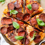 Thick crust, made in a cast iron skillet and extra cheesy. This Vegan Pepperoni Pan Pizza is 100% dairy-free and super delicious | ThisSavoryVegan.com