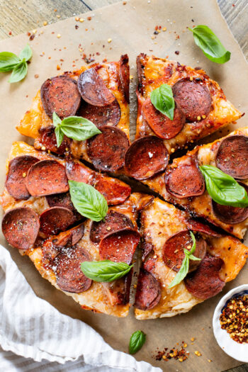 Thick crust, made in a cast iron skillet and extra cheesy. This Vegan Pepperoni Pan Pizza is 100% dairy-free and super delicious | ThisSavoryVegan.com