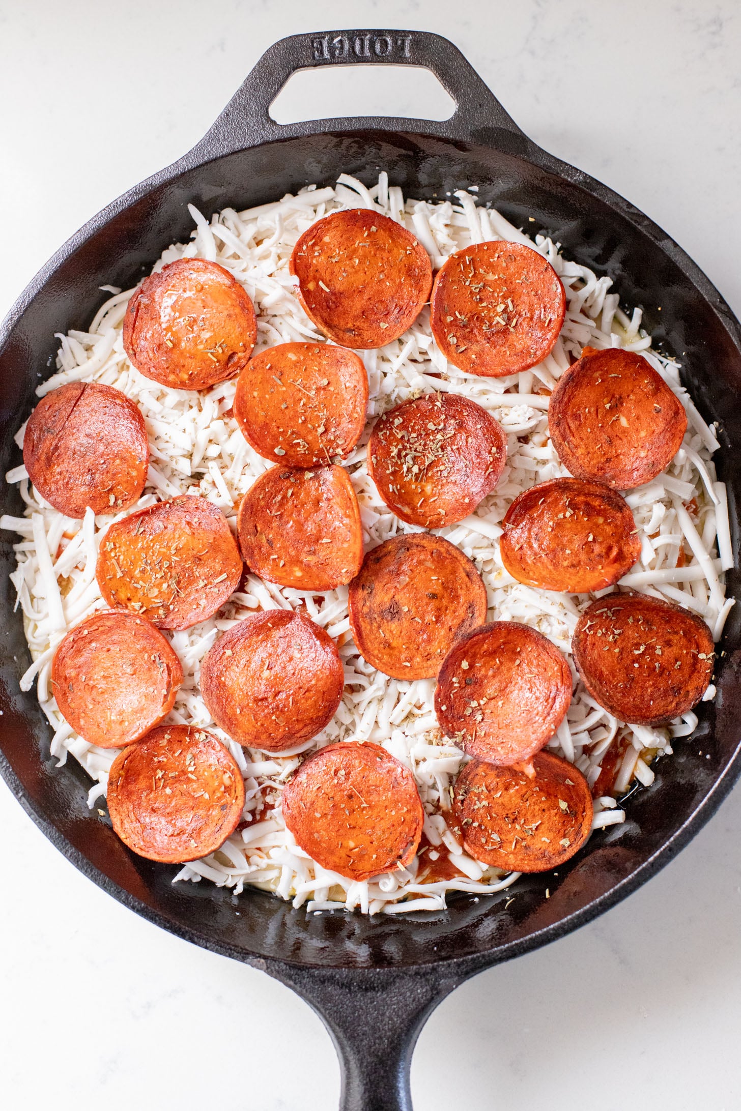 Thick crust, made in a cast iron skillet and extra cheesy. This Vegan Pepperoni Pan Pizza is 100% dairy-free and super delicious | ThisSavoryVegan.com