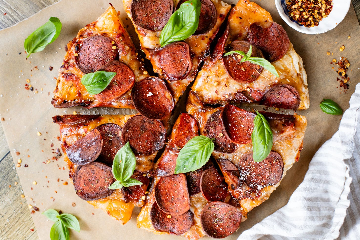 Thick crust, made in a cast iron skillet and extra cheesy. This Vegan Pepperoni Pan Pizza is 100% dairy-free and super delicious | ThisSavoryVegan.com