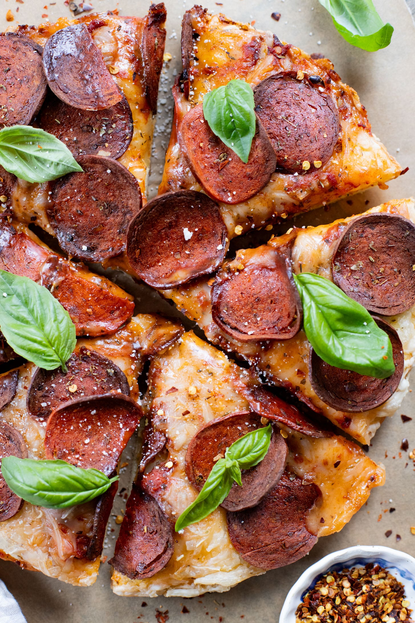 Thick crust, made in a cast iron skillet and extra cheesy. This Vegan Pepperoni Pan Pizza is 100% dairy-free and super delicious | ThisSavoryVegan.com