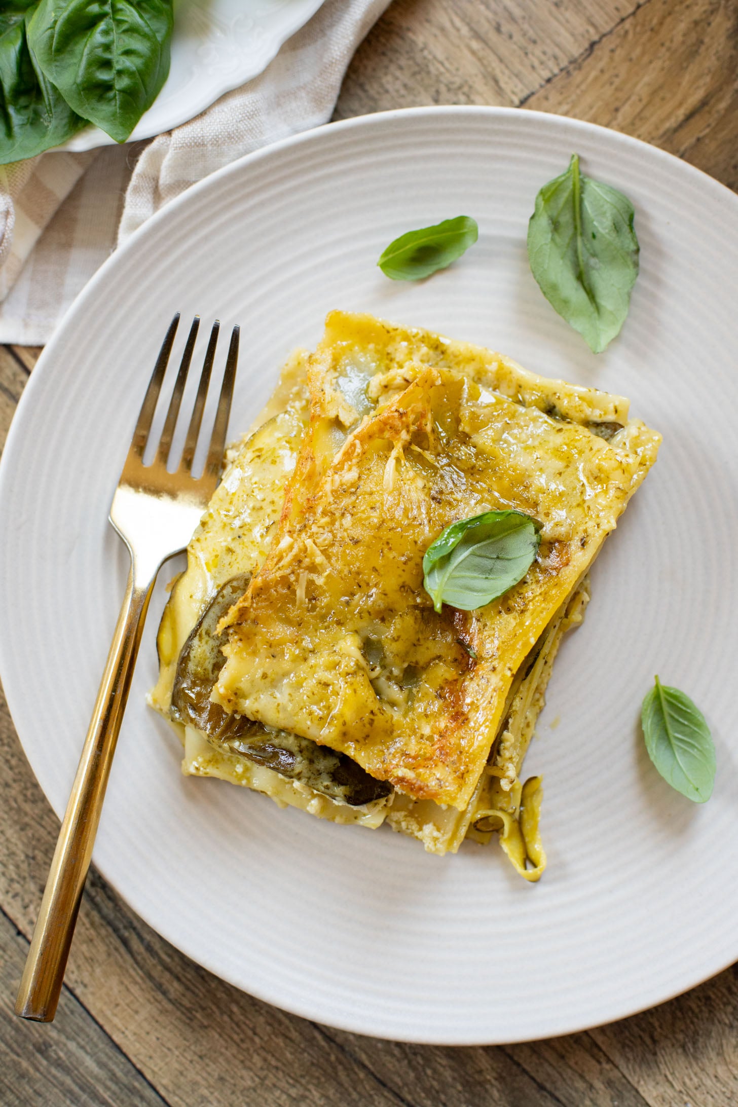 This Vegan Pesto Lasagna is layered with zucchini, spinach, lasagna noodles, tofu ricotta and a pesto béchamel sauce | ThisSavoryVegan.com