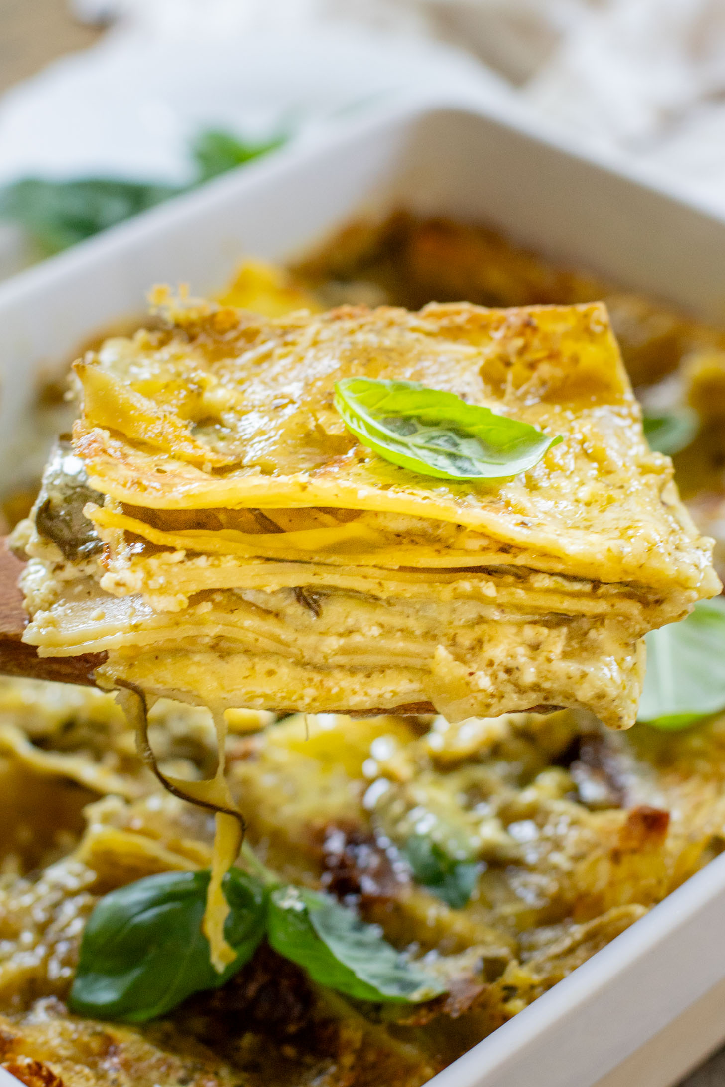 This Vegan Pesto Lasagna is layered with zucchini, spinach, lasagna noodles, tofu ricotta and a pesto béchamel sauce | ThisSavoryVegan.com