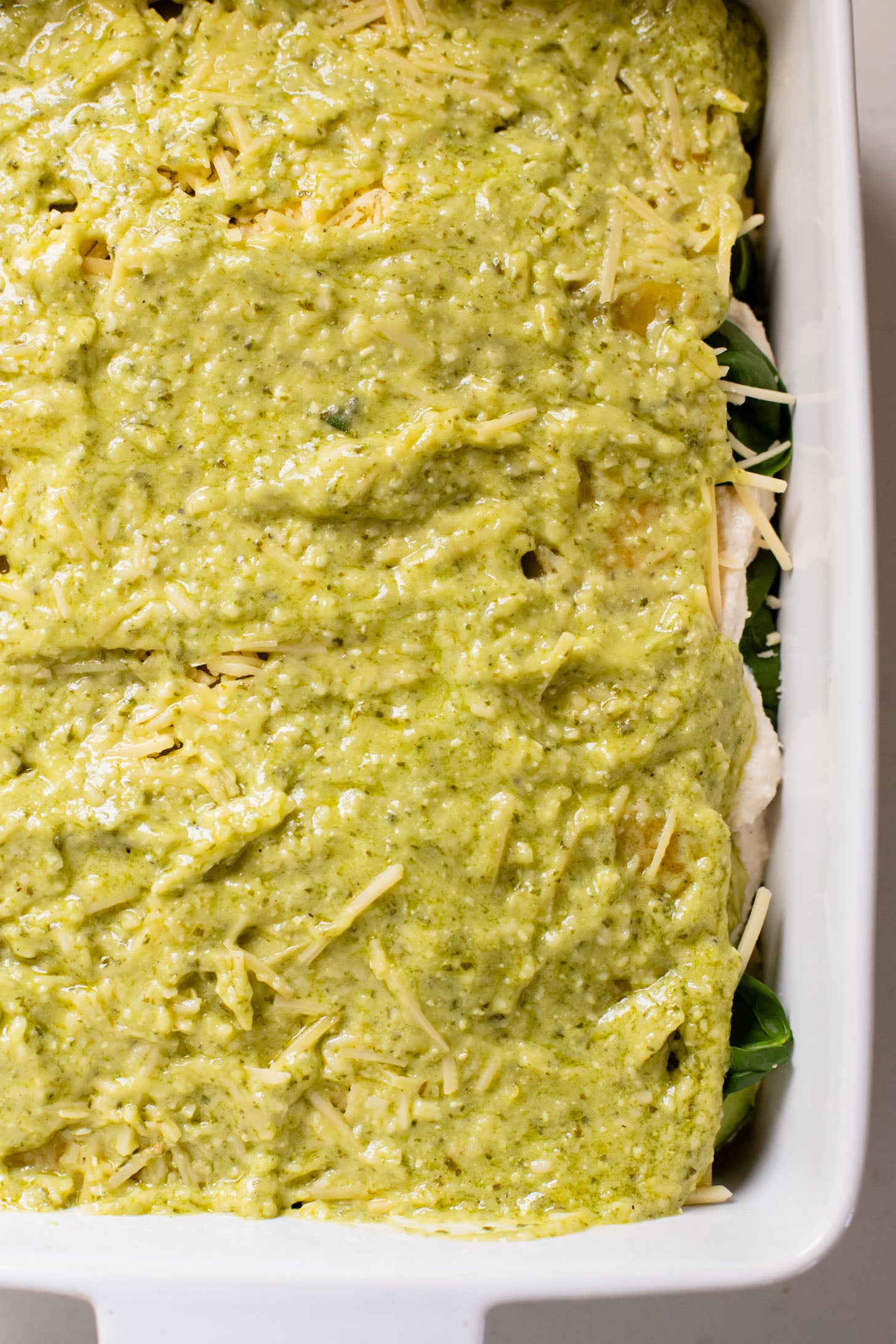 This Vegan Pesto Lasagna is layered with zucchini, spinach, lasagna noodles, tofu ricotta and a pesto béchamel sauce | ThisSavoryVegan.com