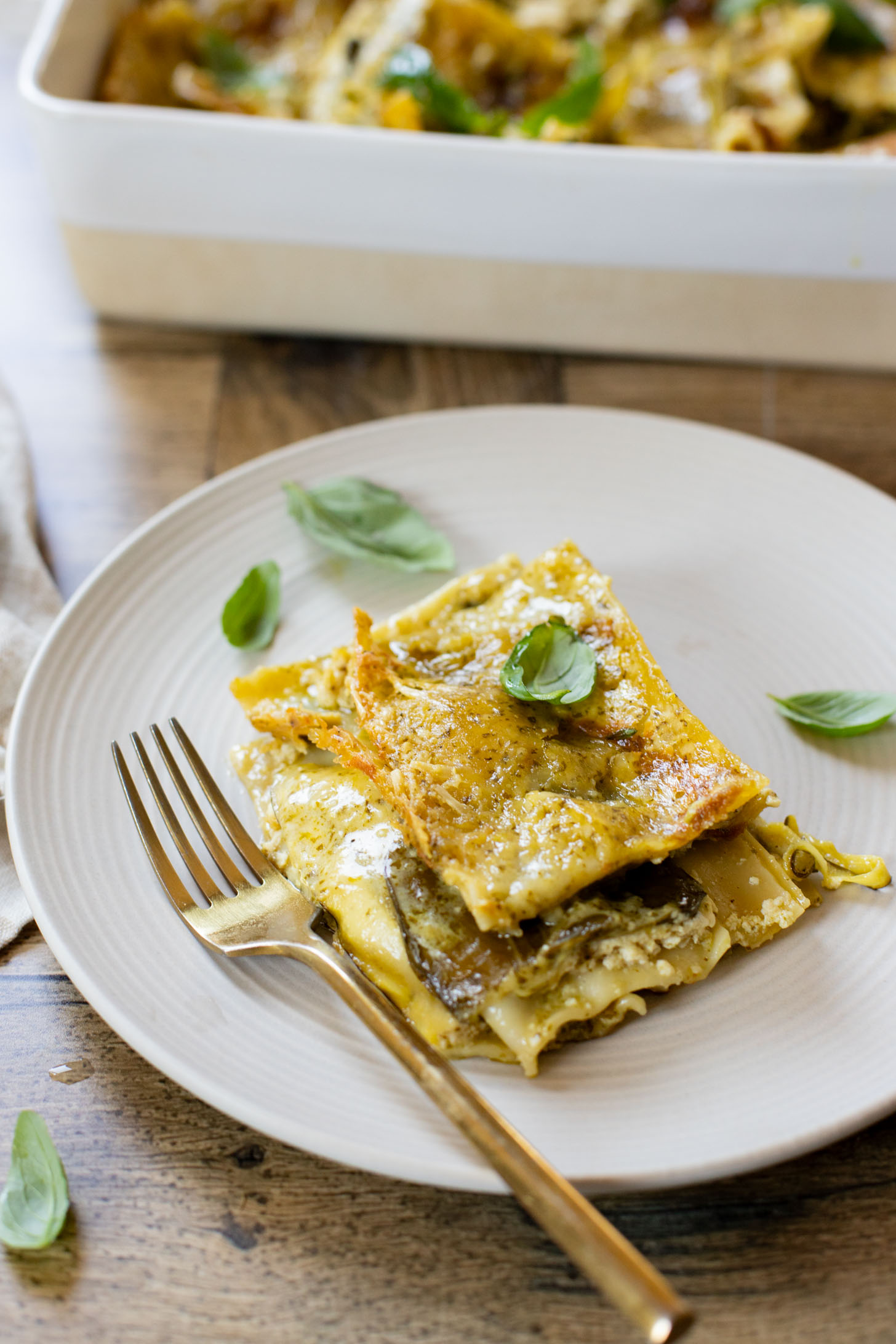 This Vegan Pesto Lasagna is layered with zucchini, spinach, lasagna noodles, tofu ricotta and a pesto béchamel sauce | ThisSavoryVegan.com