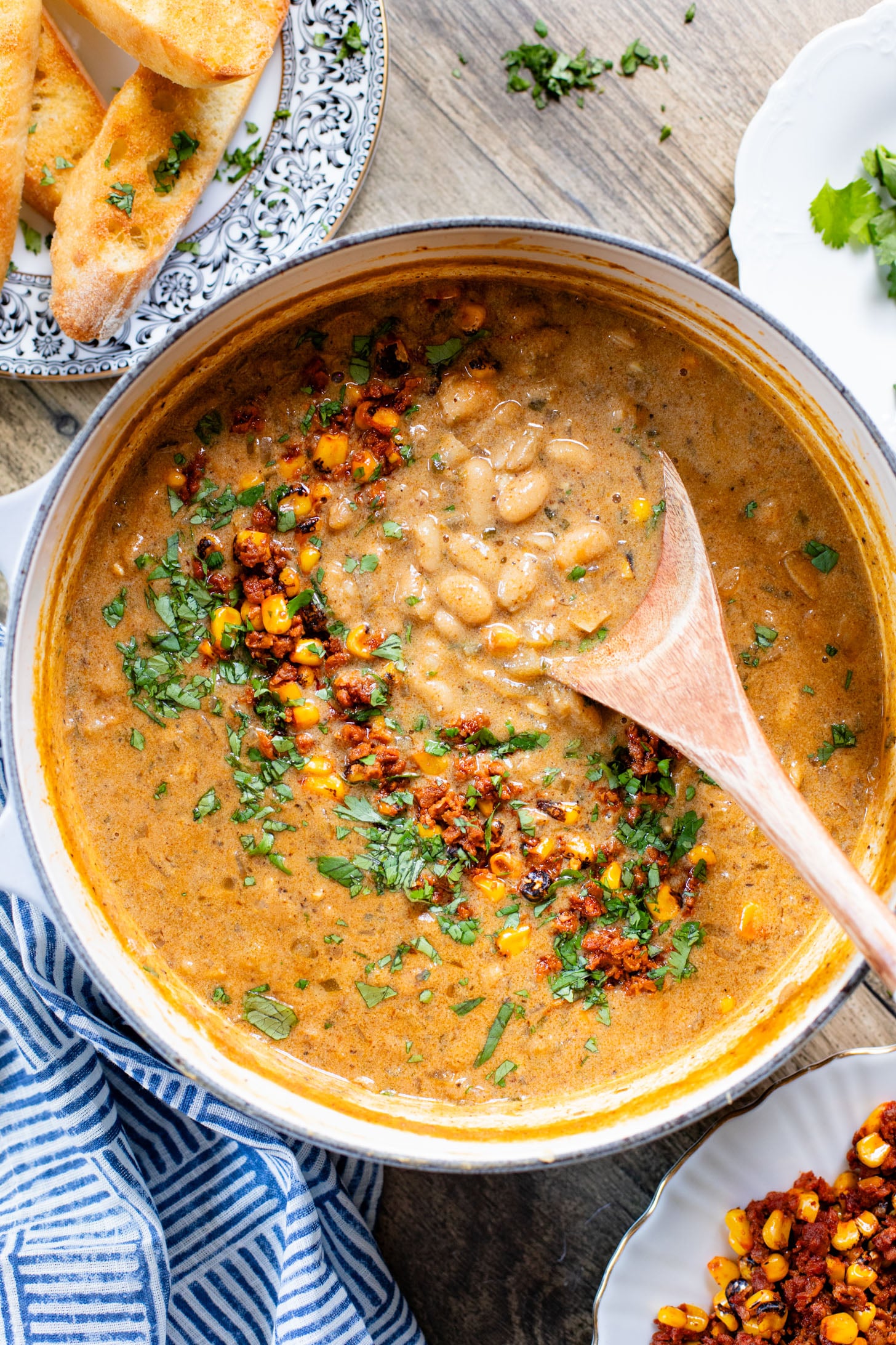 This Creamy White Beans & Soy Chorizo recipe is a cozy one-pot dinner. The beans are simmered in a creamy broth & topped with soy chorizo & corn | ThisSavoryVegan.com