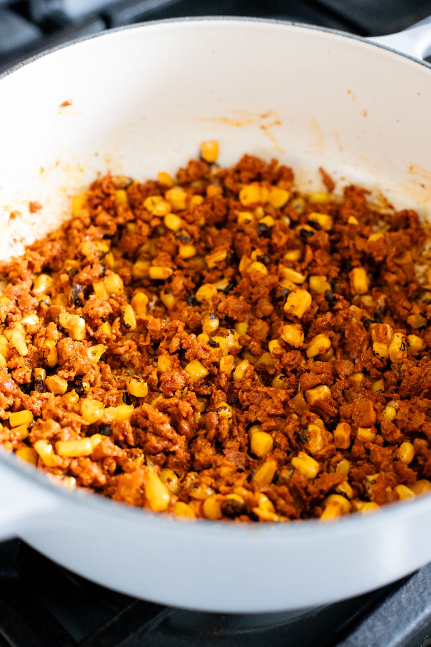 This Creamy White Beans & Soy Chorizo recipe is a cozy one-pot dinner. The beans are simmered in a creamy broth & topped with soy chorizo & corn | ThisSavoryVegan.com