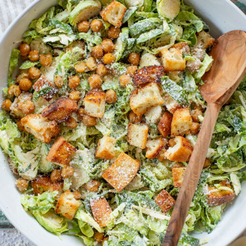 This Shaved Brussels Sprouts Caesar Salad is 100% dairy-free and totally tasty! A fall take on a classic salad recipe | ThisSavoryVegan.com