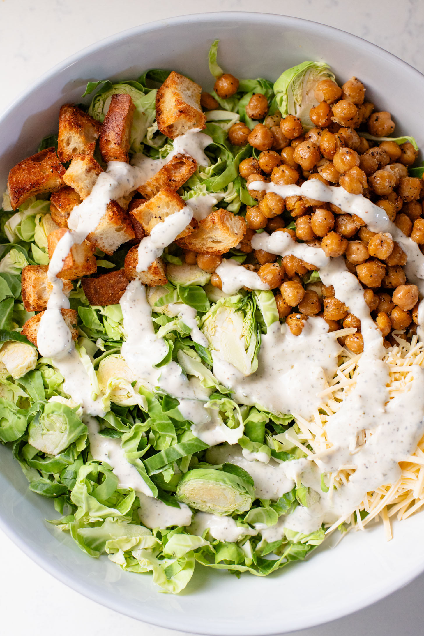 This Shaved Brussels Sprouts Caesar Salad is 100% dairy-free and totally tasty! A fall take on a classic salad recipe | ThisSavoryVegan.com