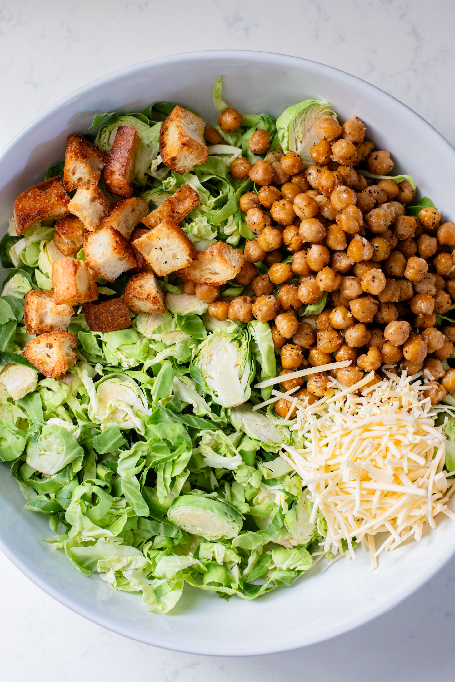 This Shaved Brussels Sprouts Caesar Salad is 100% dairy-free and totally tasty! A fall take on a classic salad recipe | ThisSavoryVegan.com