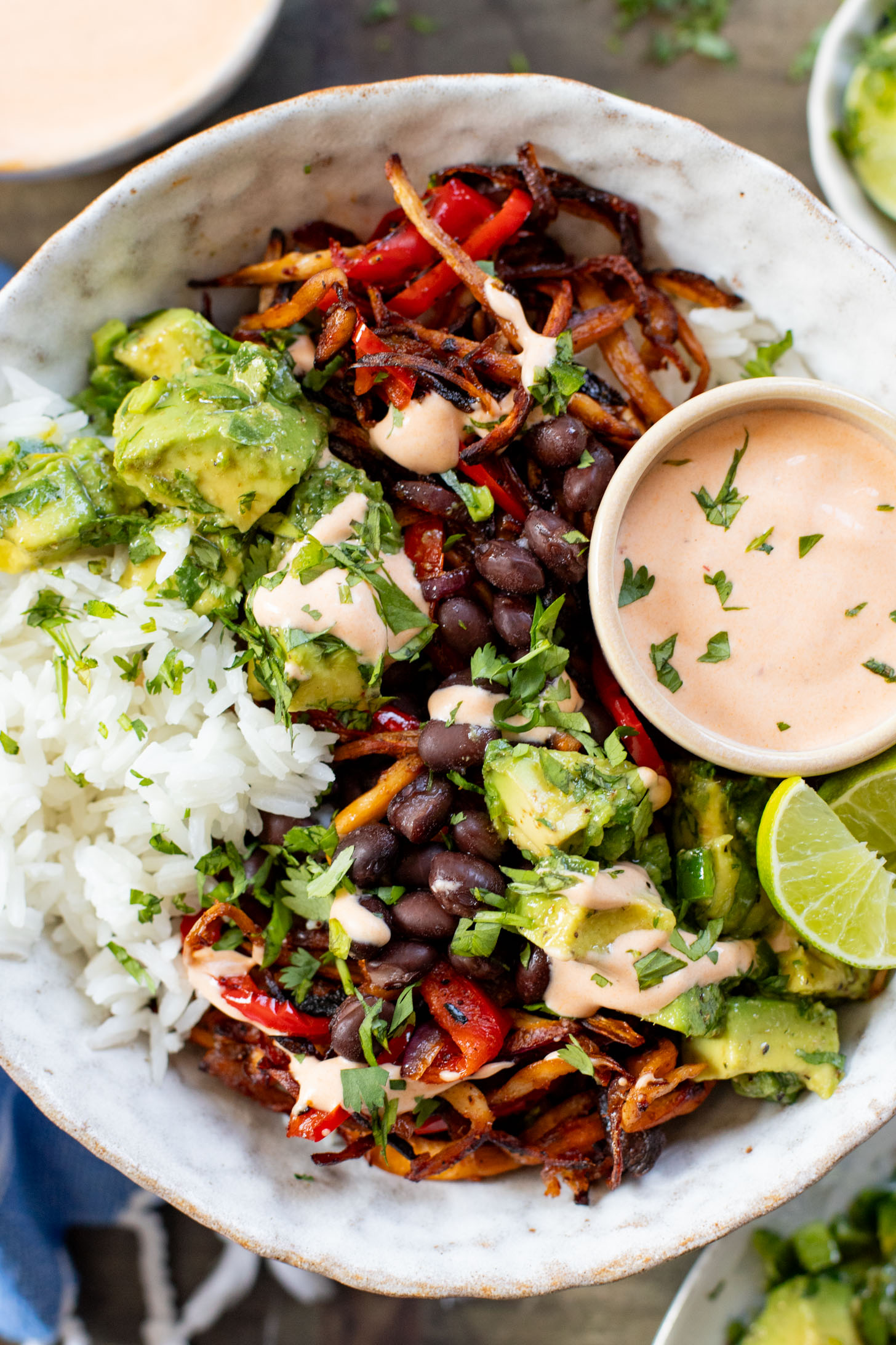 These Chipotle Oyster Mushroom Bowls are like fajitas with the addition of crispy mushrooms. Topped with avocado & dairy-free chipotle mayo | ThisSavoryVegan.com