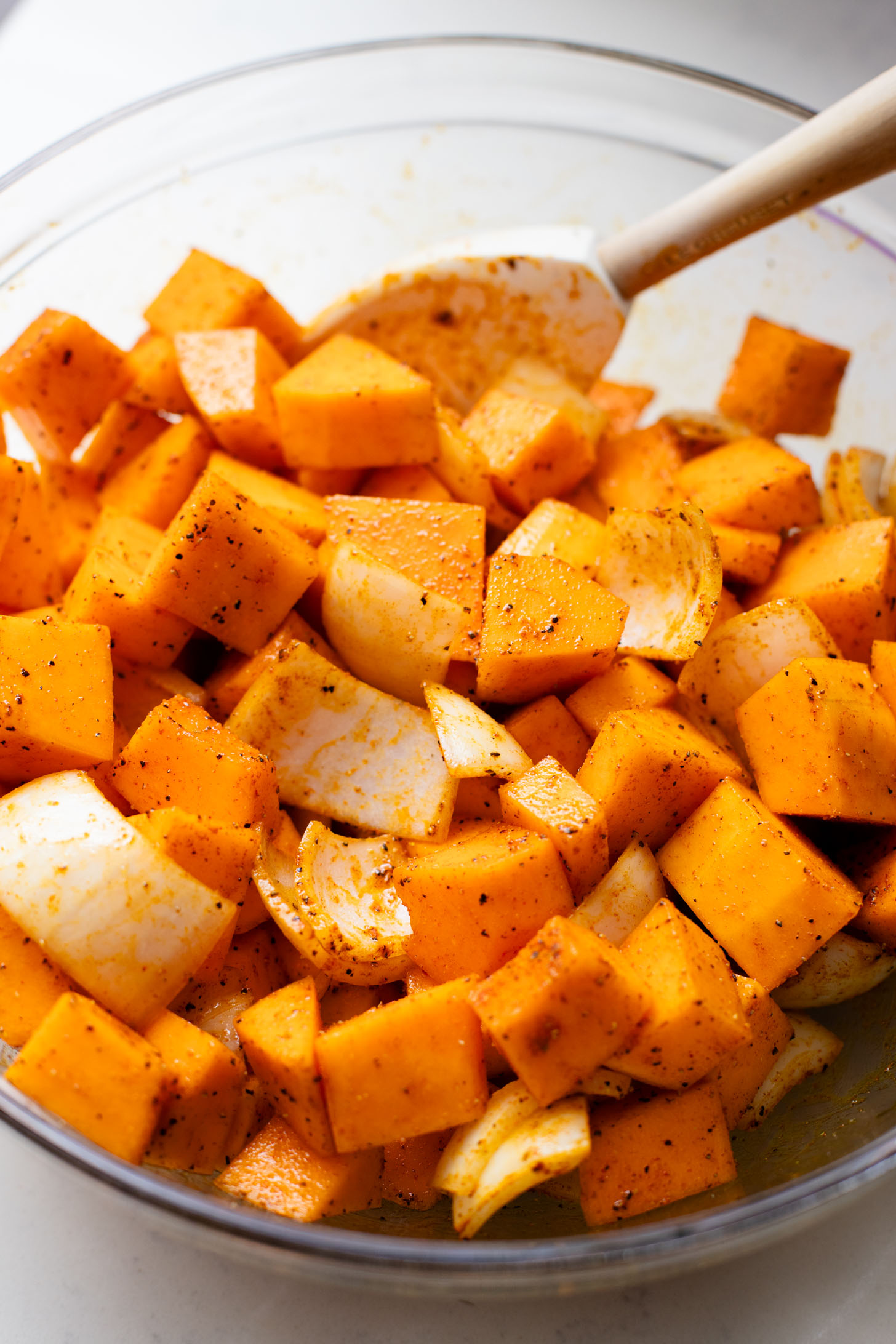 This Curried White Beans & Kale recipe is cozy and veggie packed! Beans are simmered in a coconut & squash sauce to make a delicious vegan curry | ThisSavoryVegan.com