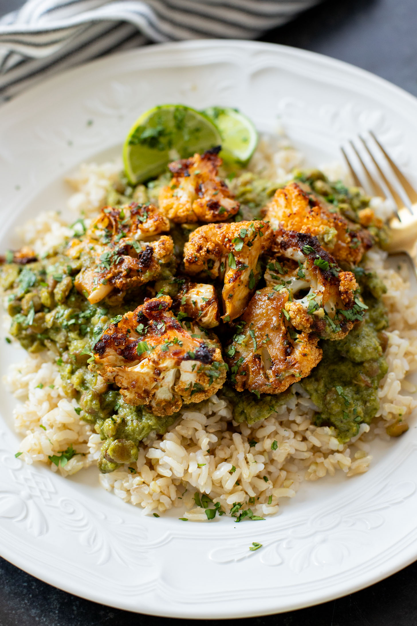 This Roasted Cauliflower in Poblano Sauce is a complete vegan dinner. Filled with lentils, crispy cauliflower & the best poblano sauce | ThisSavoryVegan.com