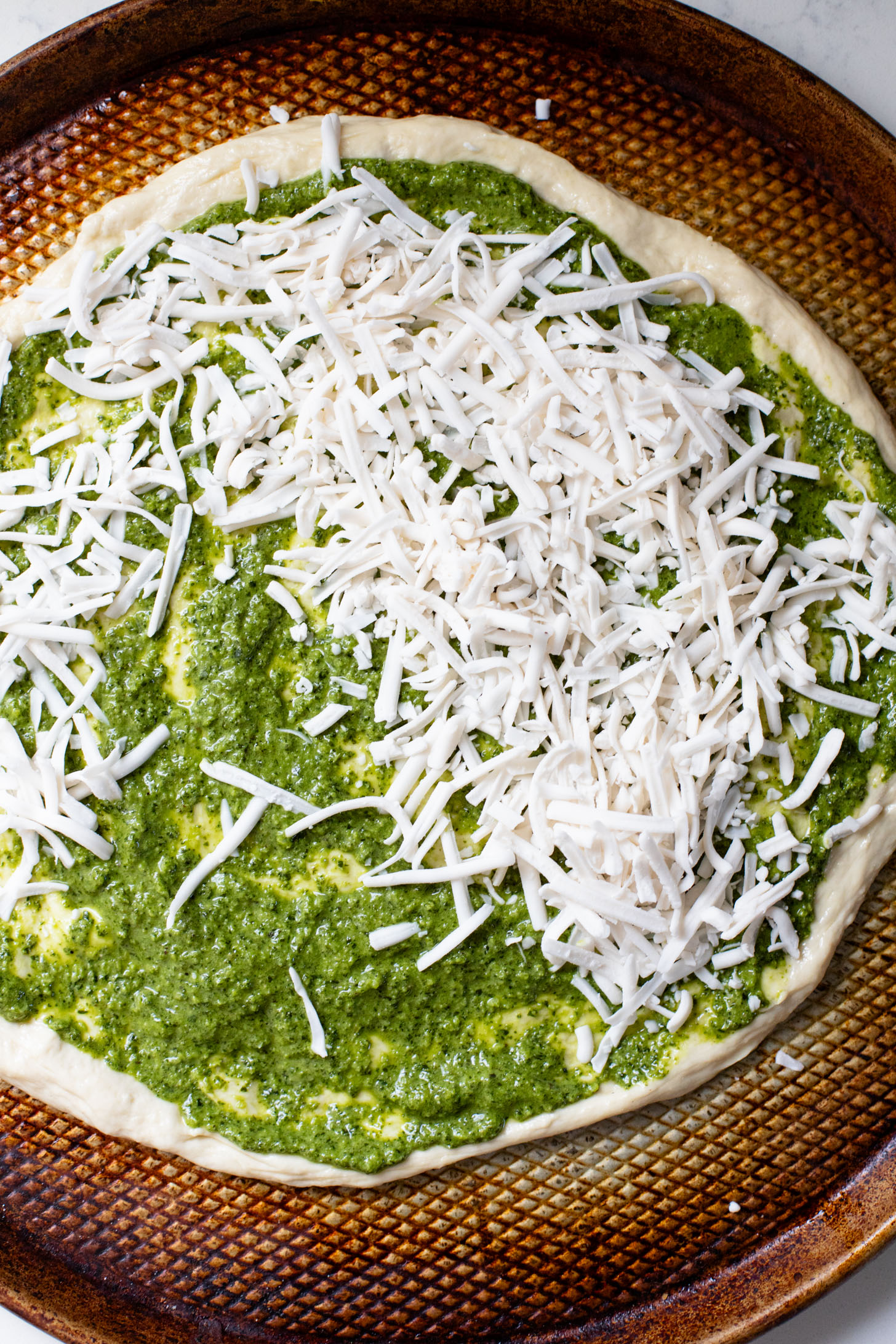 This Roasted Red Pepper Pesto Pizza is a delicious and easy vegan pizza recipe! Fresh, bright flavors on a crispy pizza crust | ThisSavoryVegan.com