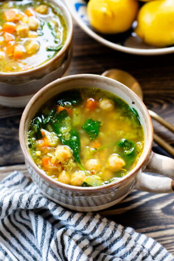 This Chickpea & Quinoa Lemon Soup is a healthy, light and tasty vegan soup recipe. Filled with veggies, chickpeas, quinoa & delicious broth | ThisSavoryVegan.com