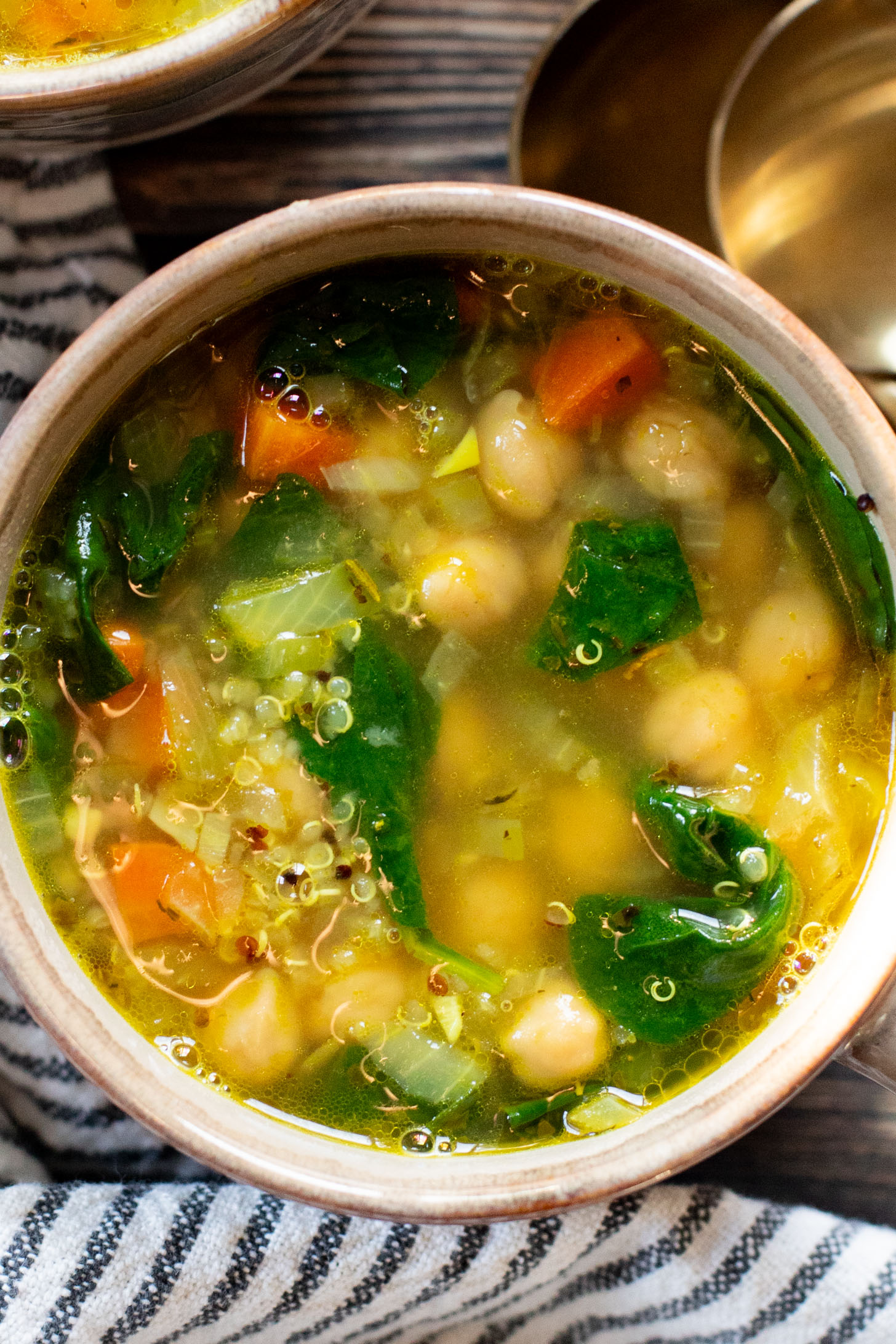 This Chickpea & Quinoa Lemon Soup is a healthy, light and tasty vegan soup recipe. Filled with veggies, chickpeas, quinoa & delicious broth | ThisSavoryVegan.com