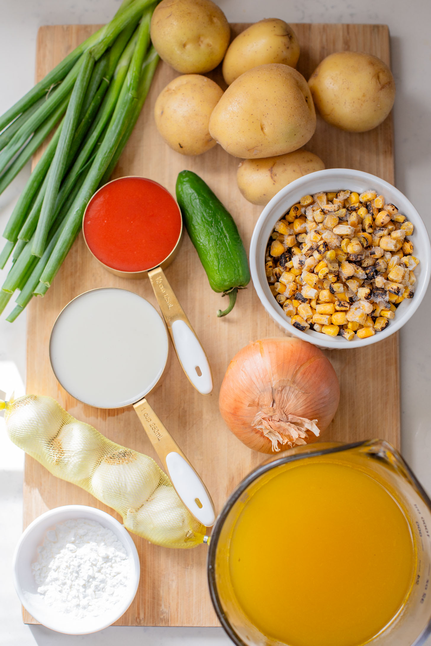 This Buffalo Potato Corn Chowder is a hearty one-pot soup that is 100% dairy-free! Serve with your favorite toppings for a cozy dinner with some spice | ThisSavoryVegan.com