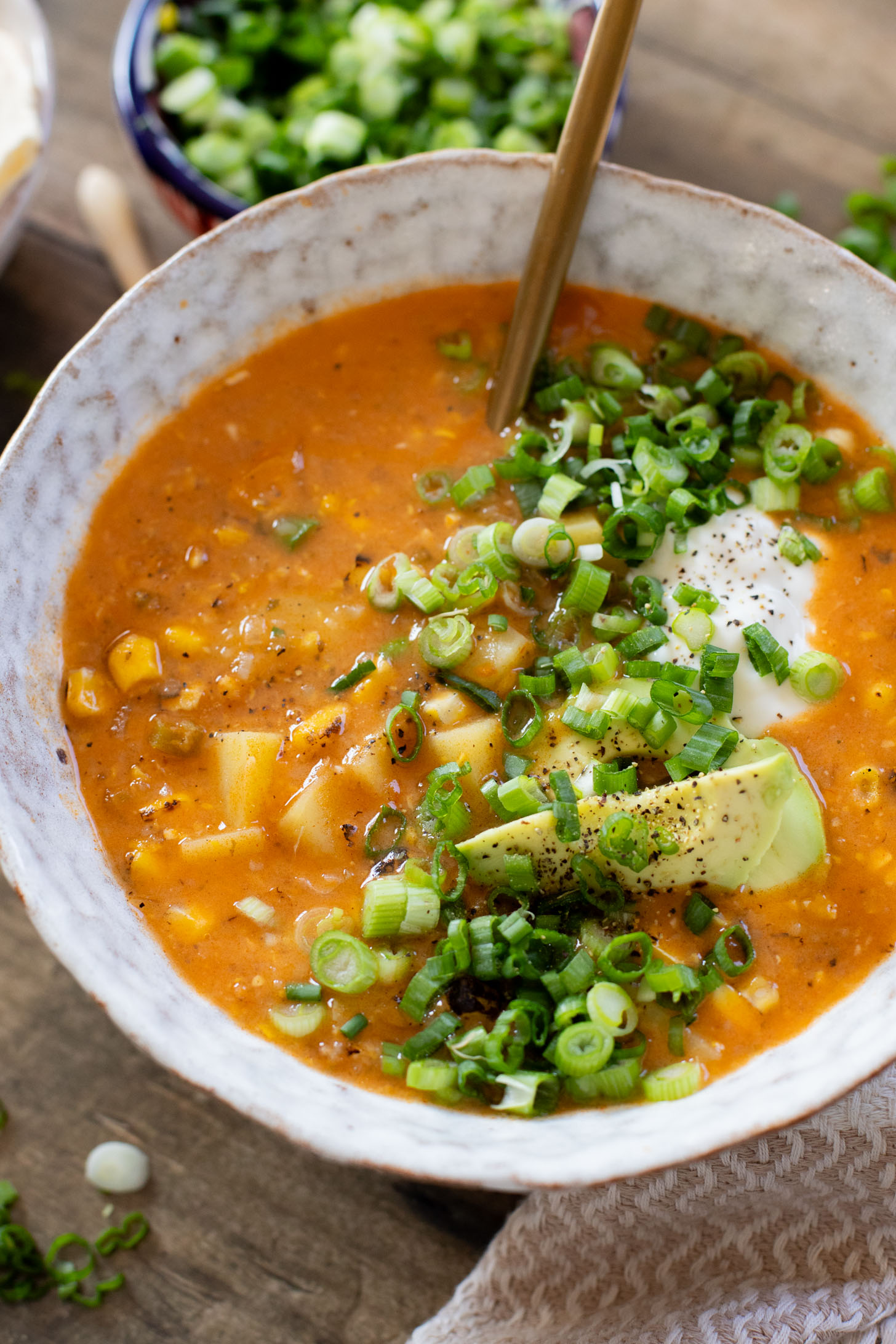 This Buffalo Potato Corn Chowder is a hearty one-pot soup that is 100% dairy-free! Serve with your favorite toppings for a cozy dinner with some spice | ThisSavoryVegan.com