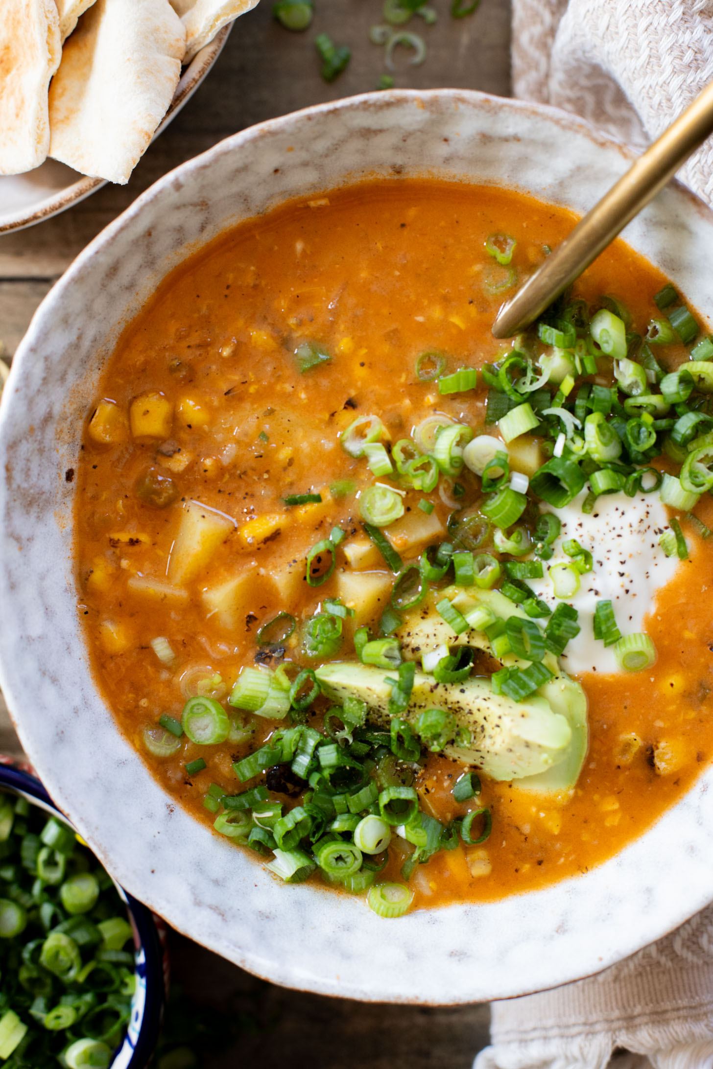 This Buffalo Potato Corn Chowder is a hearty one-pot soup that is 100% dairy-free! Serve with your favorite toppings for a cozy dinner with some spice | ThisSavoryVegan.com