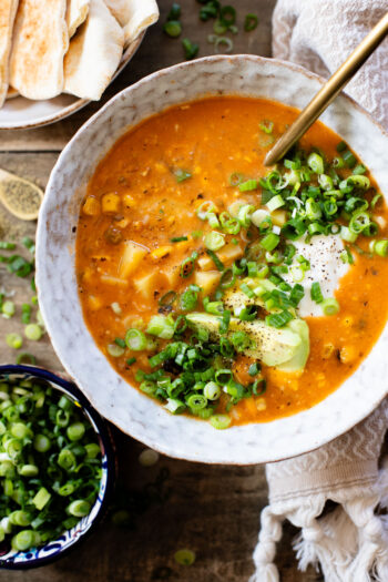 This Buffalo Potato Corn Chowder is a hearty one-pot soup that is 100% dairy-free! Serve with your favorite toppings for a cozy dinner with some spice | ThisSavoryVegan.com
