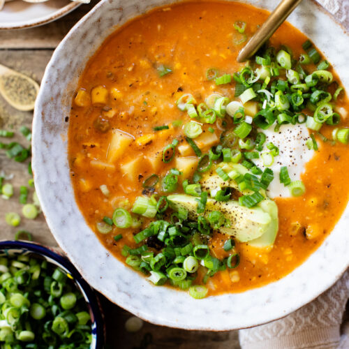 This Buffalo Potato Corn Chowder is a hearty one-pot soup that is 100% dairy-free! Serve with your favorite toppings for a cozy dinner with some spice | ThisSavoryVegan.com