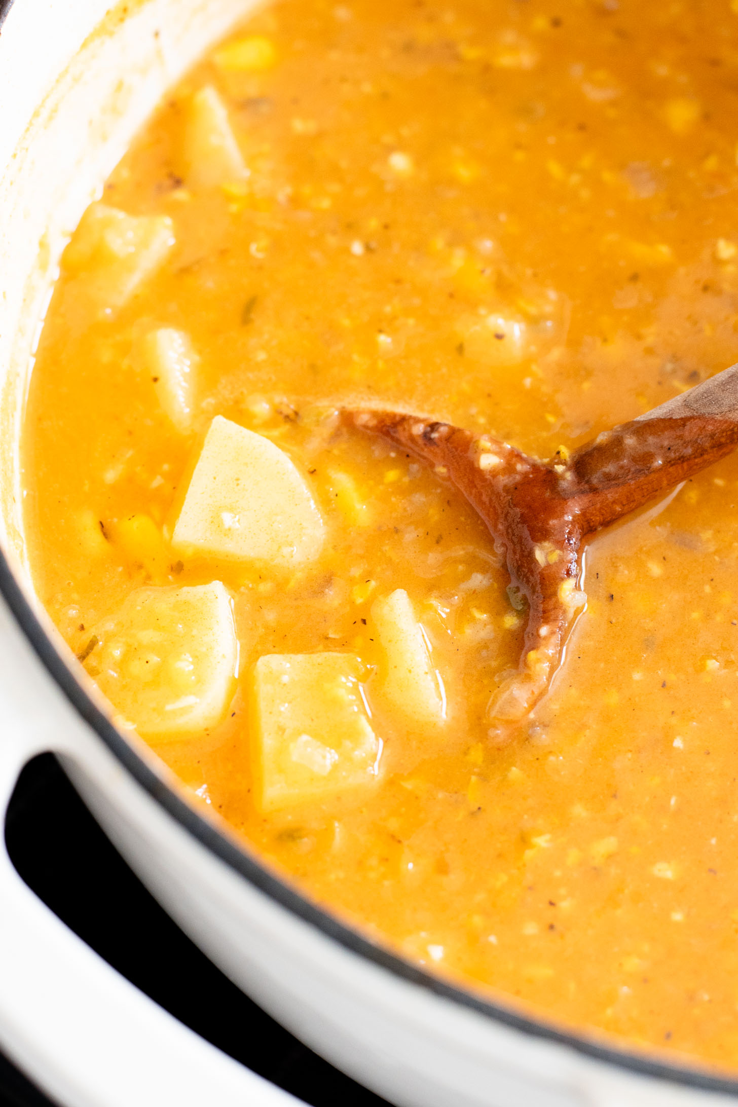 This Buffalo Potato Corn Chowder is a hearty one-pot soup that is 100% dairy-free! Serve with your favorite toppings for a cozy dinner with some spice | ThisSavoryVegan.com