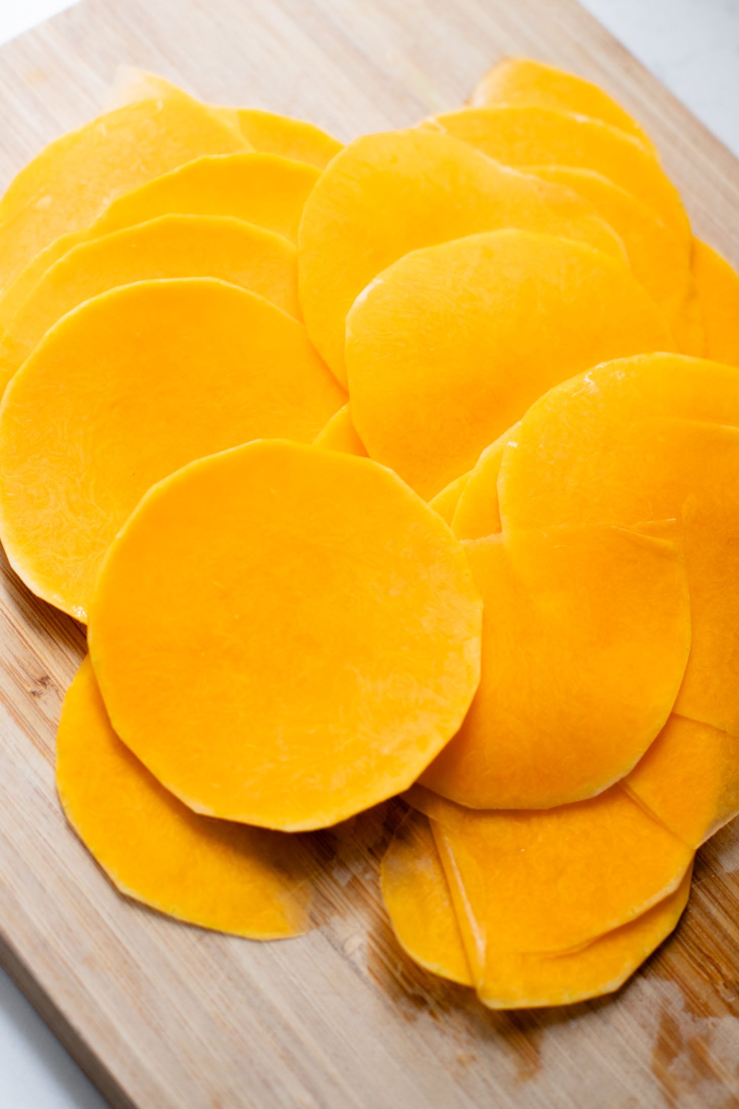 This Cheesy Butternut Squash Tart is the perfect holiday appetizer! Puff pastry is layered with non-dairy cheese and thinly sliced butternut squash | ThisSavoryVegan.com