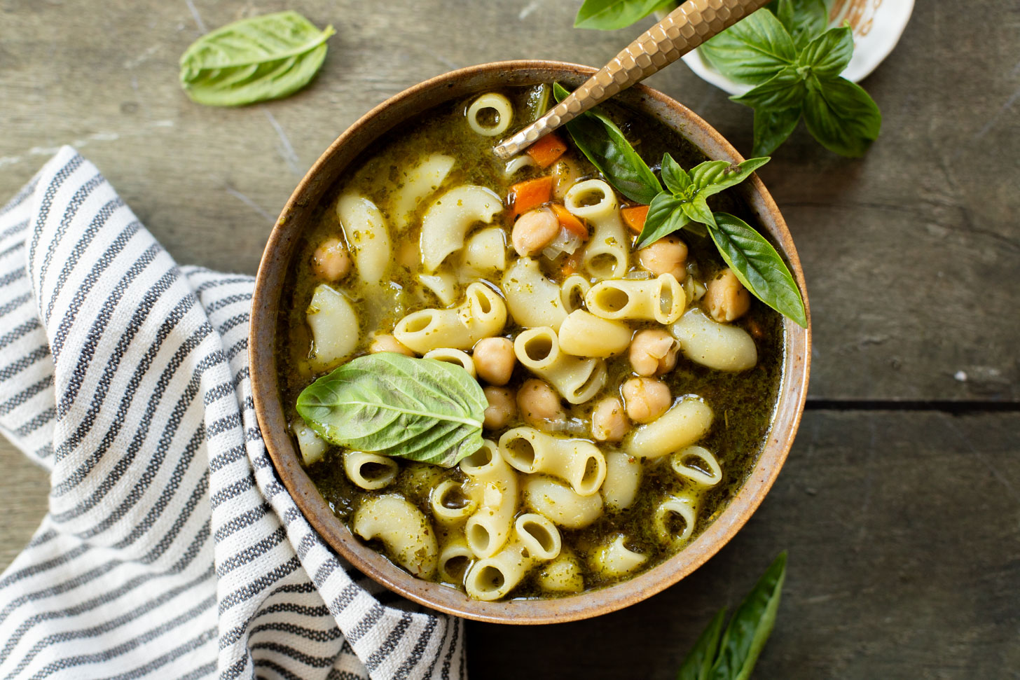 This Chickpea Pesto Macaroni Soup is a quick and tasty vegan soup recipe. A tasty broth, tender macaroni, chickpeas & veggies | ThisSavoryVegan.com