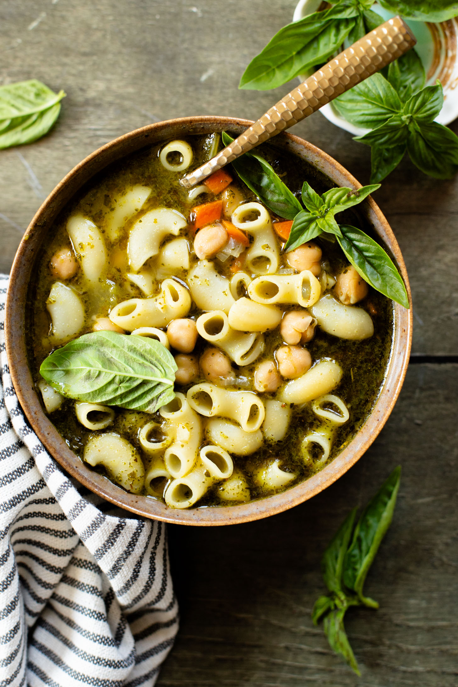 This Chickpea Pesto Macaroni Soup is a quick and tasty vegan soup recipe. A tasty broth, tender macaroni, chickpeas & veggies | ThisSavoryVegan.com