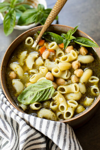 This Chickpea Pesto Macaroni Soup is a quick and tasty vegan soup recipe. A tasty broth, tender macaroni, chickpeas & veggies | ThisSavoryVegan.com