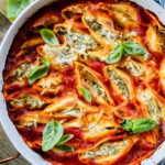 These Delicious Vegan Stuffed Shells are simple to make and even easier to eat. Filled with homemade tofu ricotta, spinach & basil in marinara | ThisSavoryVegan.com