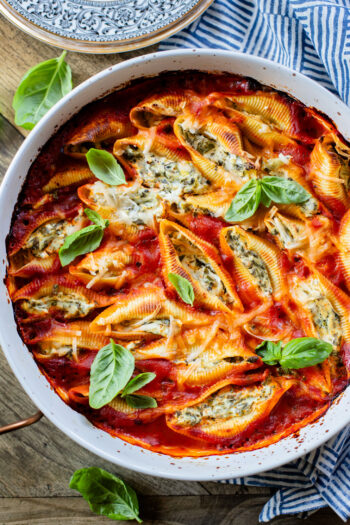 These Delicious Vegan Stuffed Shells are simple to make and even easier to eat. Filled with homemade tofu ricotta, spinach & basil in marinara | ThisSavoryVegan.com