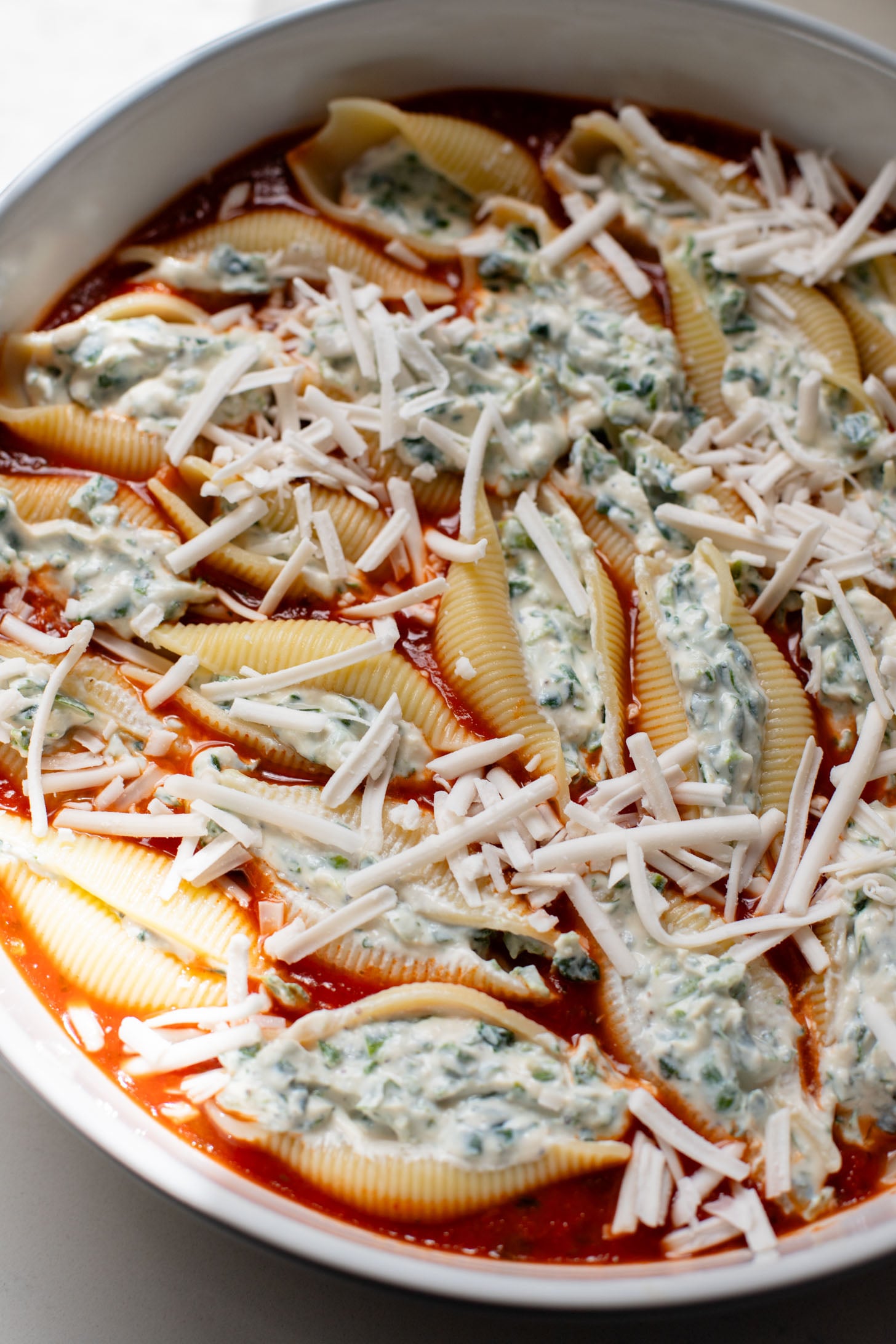 These Delicious Vegan Stuffed Shells are simple to make and even easier to eat. Filled with homemade tofu ricotta, spinach & basil in marinara | ThisSavoryVegan.com
