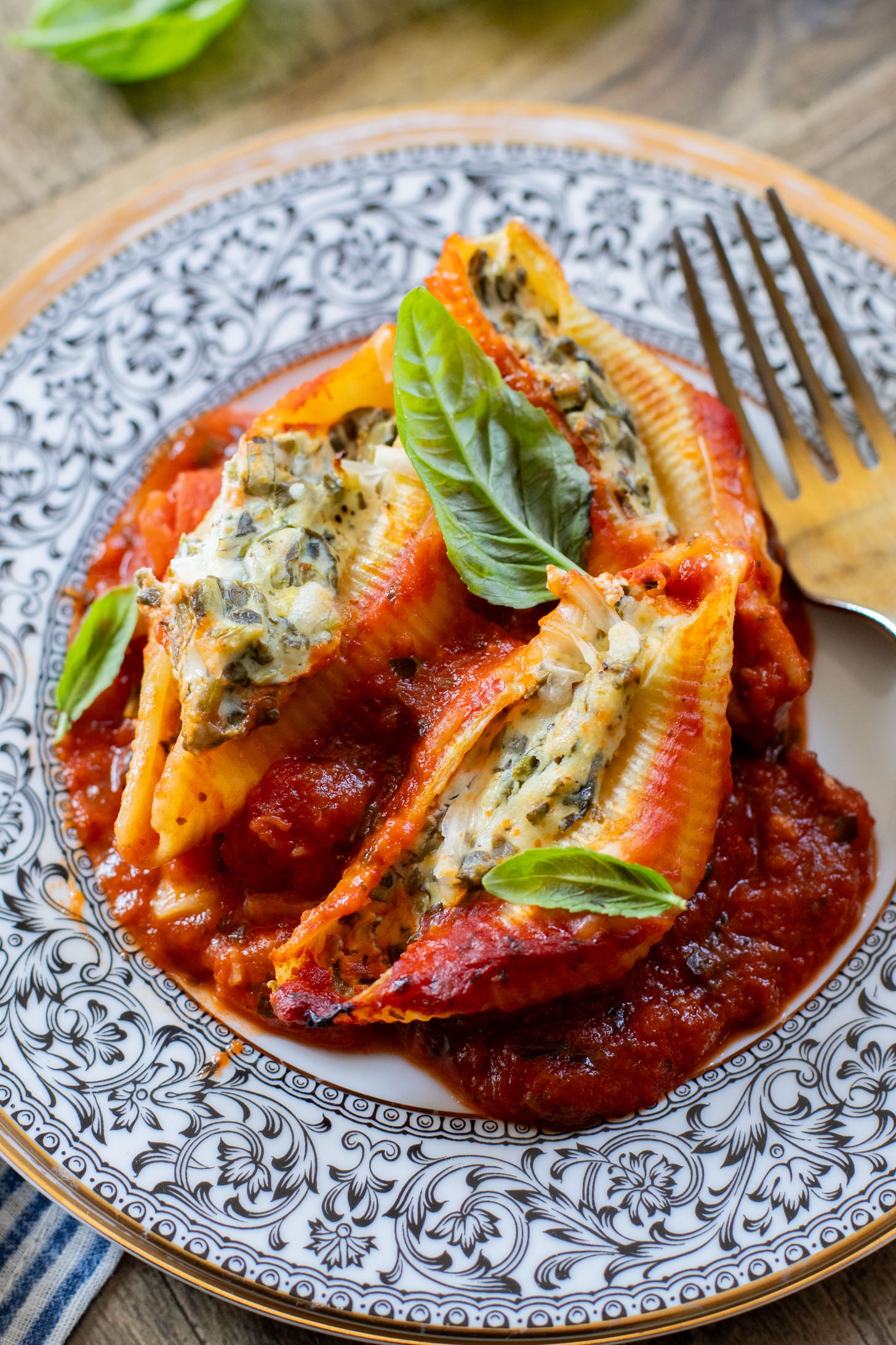 These Delicious Vegan Stuffed Shells are simple to make and even easier to eat. Filled with homemade tofu ricotta, spinach & basil in marinara | ThisSavoryVegan.com