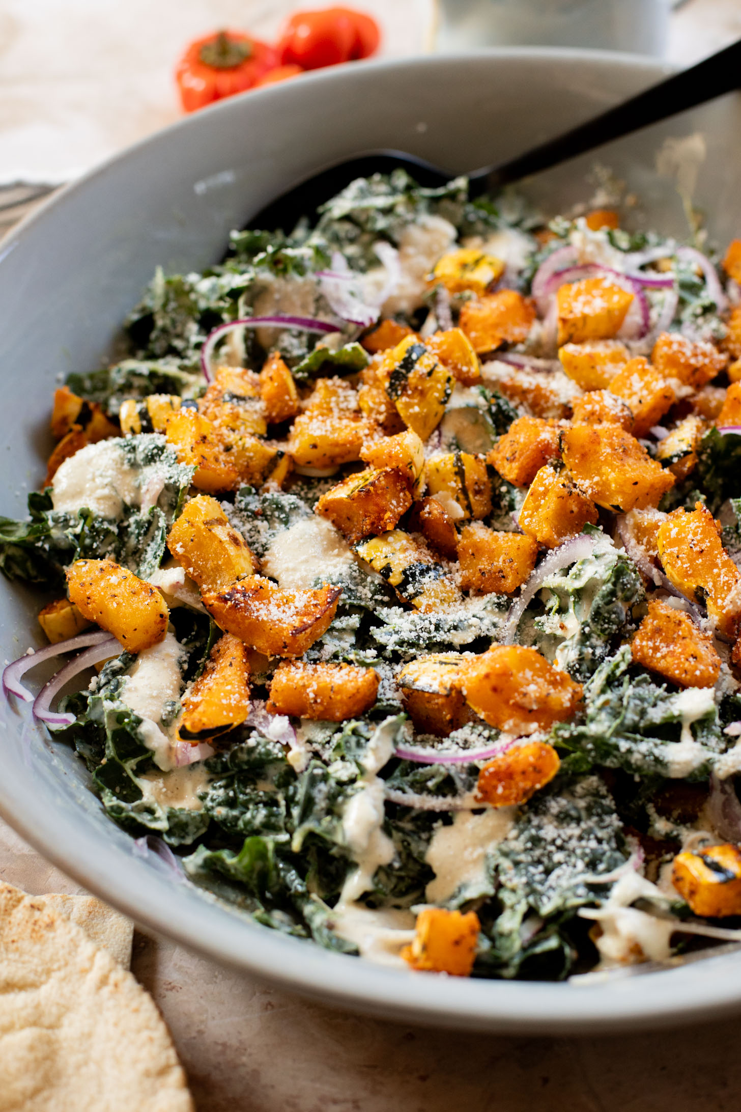 This Fall Harvest Salad is filled with roasted delicata squash, kale & red onion tossed in a creamy tahini dressing. Serve as a main or a side | ThisSavoryVegan.com