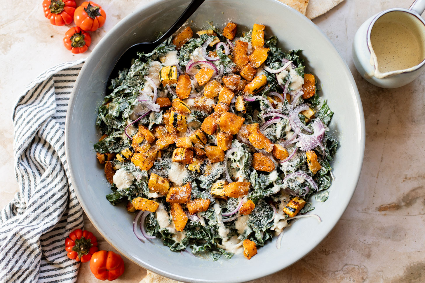 This Fall Harvest Salad is filled with roasted delicata squash, kale & red onion tossed in a creamy tahini dressing. Serve as a main or a side | ThisSavoryVegan.com