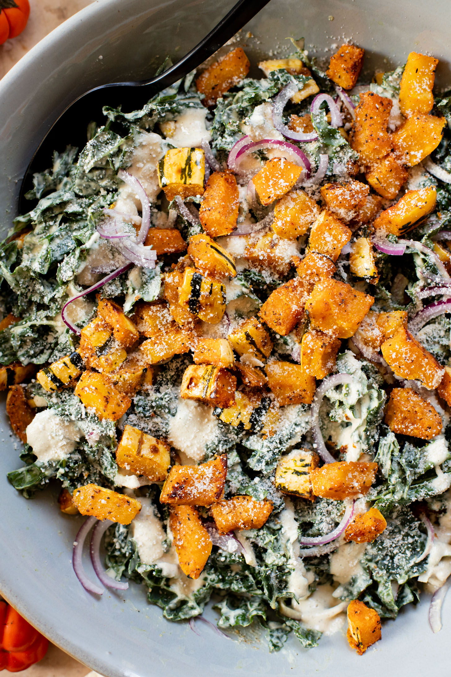 This Fall Harvest Salad is filled with roasted delicata squash, kale & red onion tossed in a creamy tahini dressing. Serve as a main or a side | ThisSavoryVegan.com