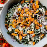This Fall Harvest Salad is filled with roasted delicata squash, kale & red onion tossed in a creamy tahini dressing. Serve as a main or a side | ThisSavoryVegan.com