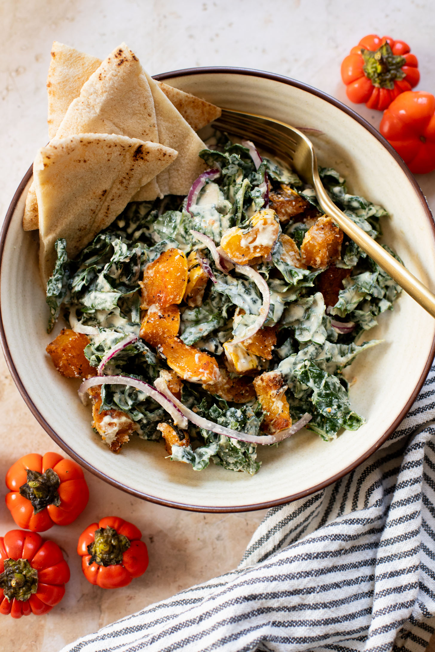 This Fall Harvest Salad is filled with roasted delicata squash, kale & red onion tossed in a creamy tahini dressing. Serve as a main or a side | ThisSavoryVegan.com