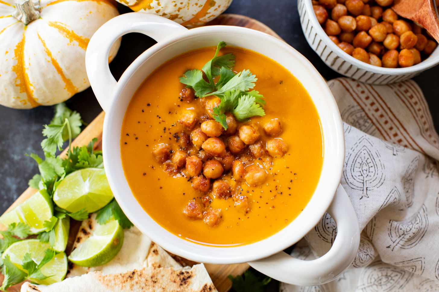 Creamy and comforting, this Thai Curry Pumpkin Soup is a dairy-free fall soup that everyone will love. Topped with crispy chickpeas | ThisSavoryVegan.com